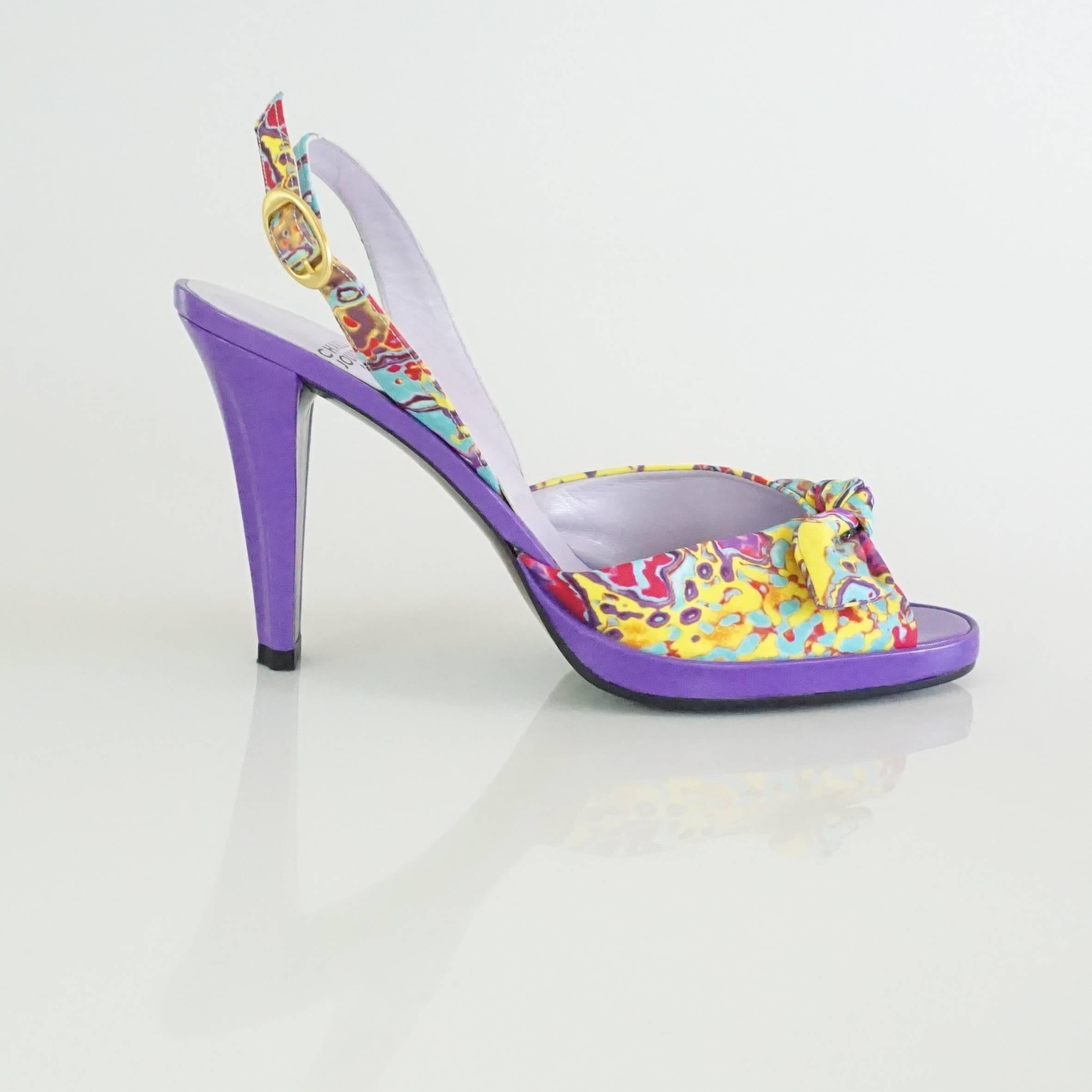 Charles Jourdan Purple & Multi Platform Slingbacks - 8.5. These open toe heels have an very unique and playful look. They feature an abstract multicolor print with purple, yellow, pink, and blue, purple leather, gold buckle on the strap, and a front