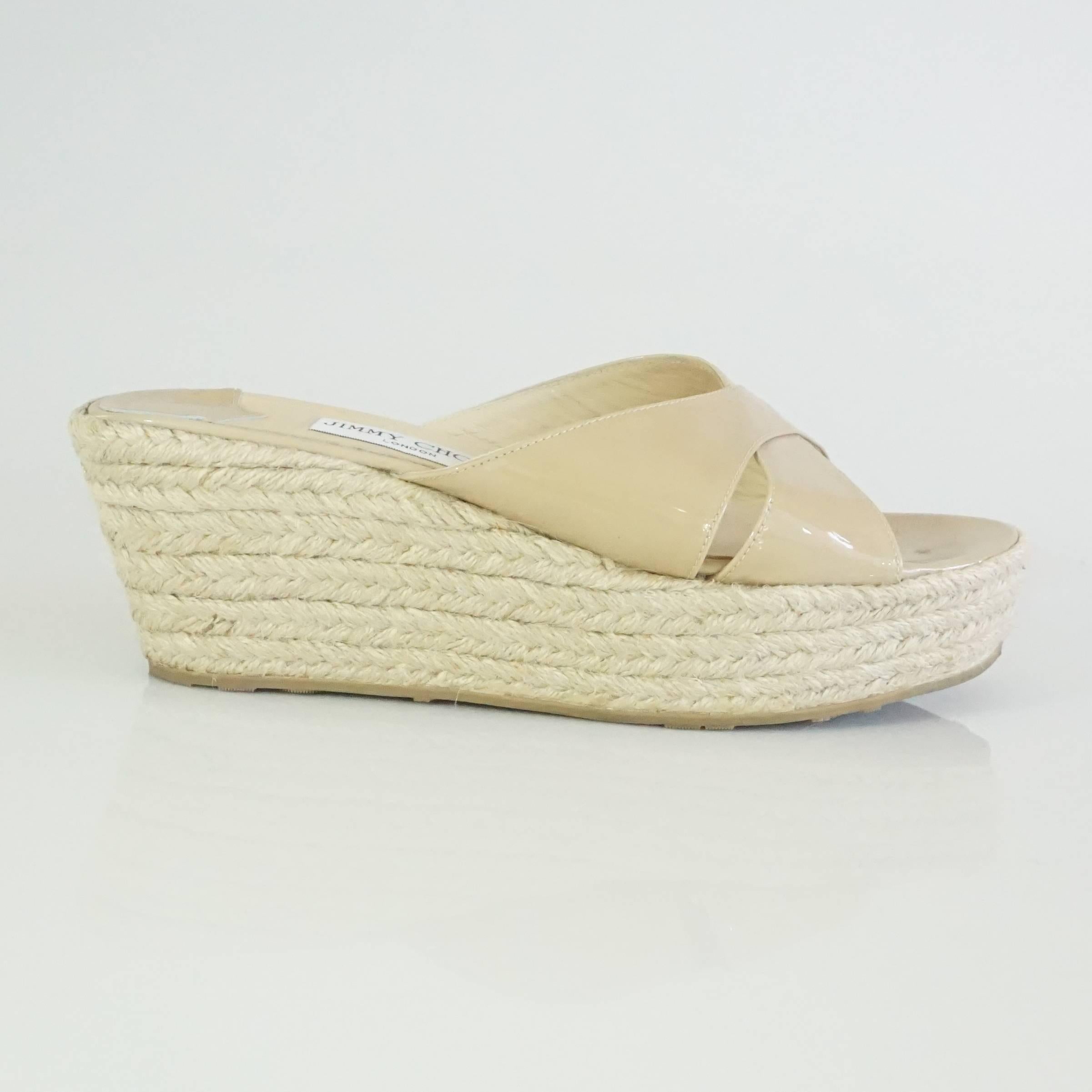 Jimmy Choo Tan Patent Straw Wedges - 40. These wedges are a staple piece for any closet and are very versatile. They feature a slight incline, crossing front straps, and a small gold 