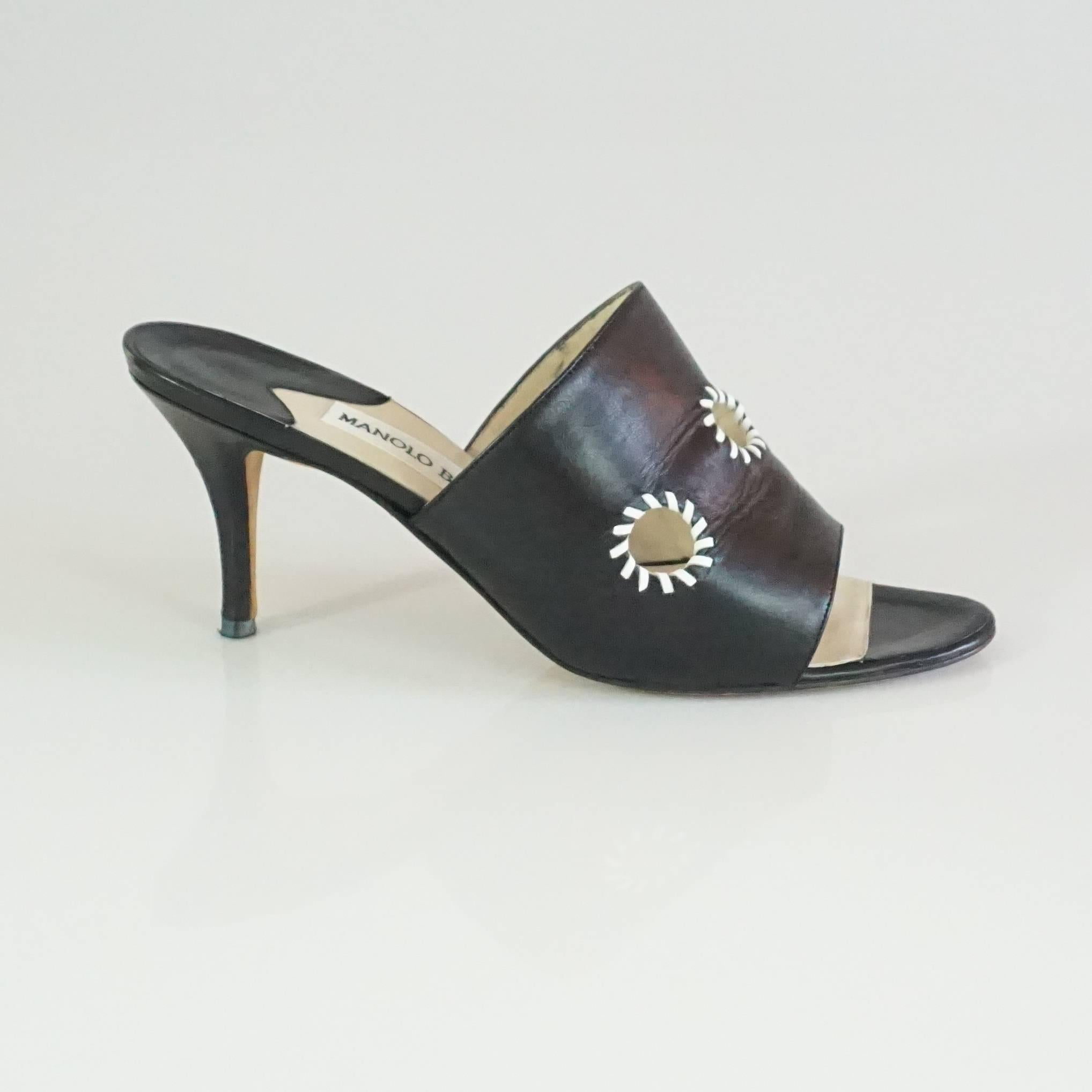 Manolo Blahnik Black Leather Mules with White Stitched Cutouts - 37. These shoes are a trendy everyday wear. They feature 3 cutouts with white stitching around them. They are in excellent condition with some bottom wear and very minor slight marks