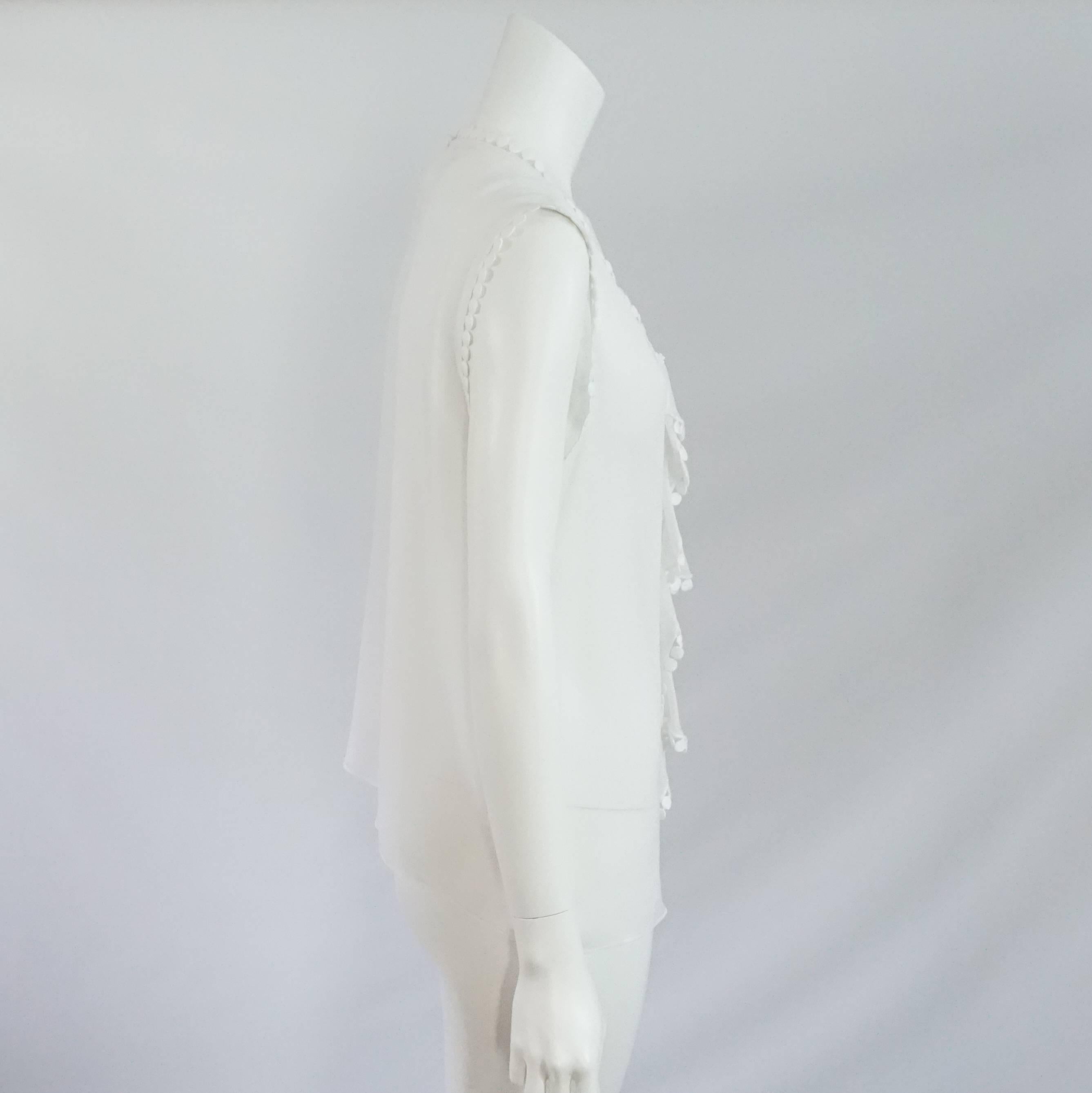 Oscar de la Renta White Silk Chiffon & Lace Top - 12. This gorgeous top has a very fresh and elegant look. It features a front ruffle detailing, lace trim, and a keyhole opening on the back. It is in excellent condition with 2 very light marks by