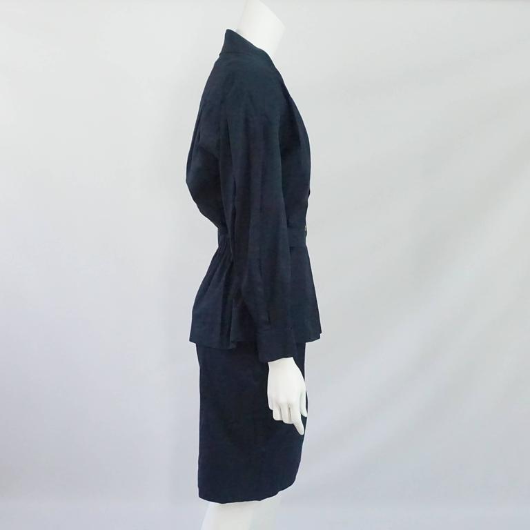 Chanel Navy Cotton Skirt Suit with Cinched Waist - 38 - 1980's. This set is a classic Chanel look. The straight skirt has a a waistband and a back zipper. The jacket is double breasted with a single row of 5 buttons with gold camellias showing. It