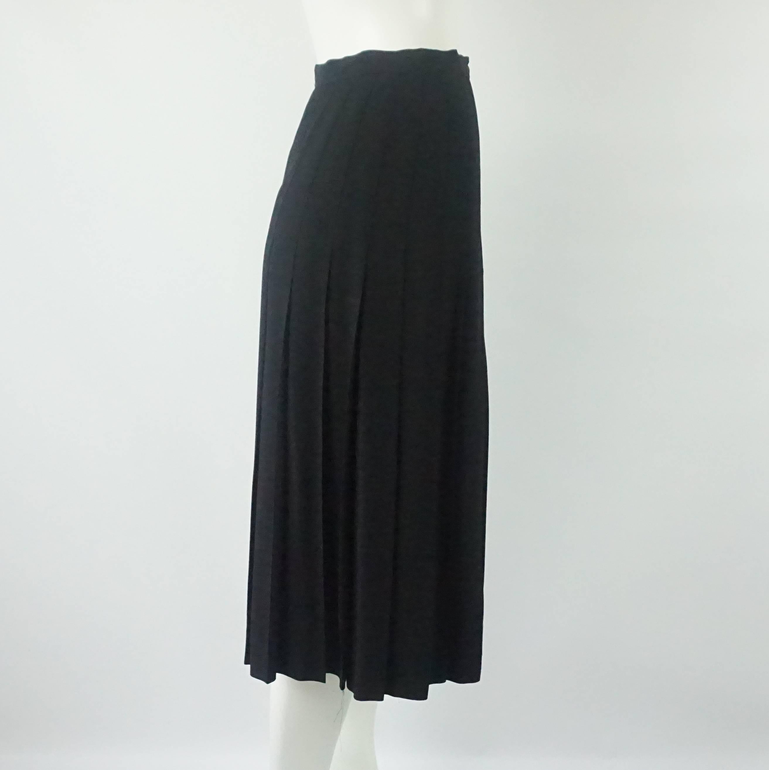 Chanel Vintage Black Silk Pleated Skirt - 38. This vintage Chanel skirt is black silk and has a gold button. It is flowing and pleated. This skirt is in excellent condition. Size 38. 

Measurements
Waist: 26.5