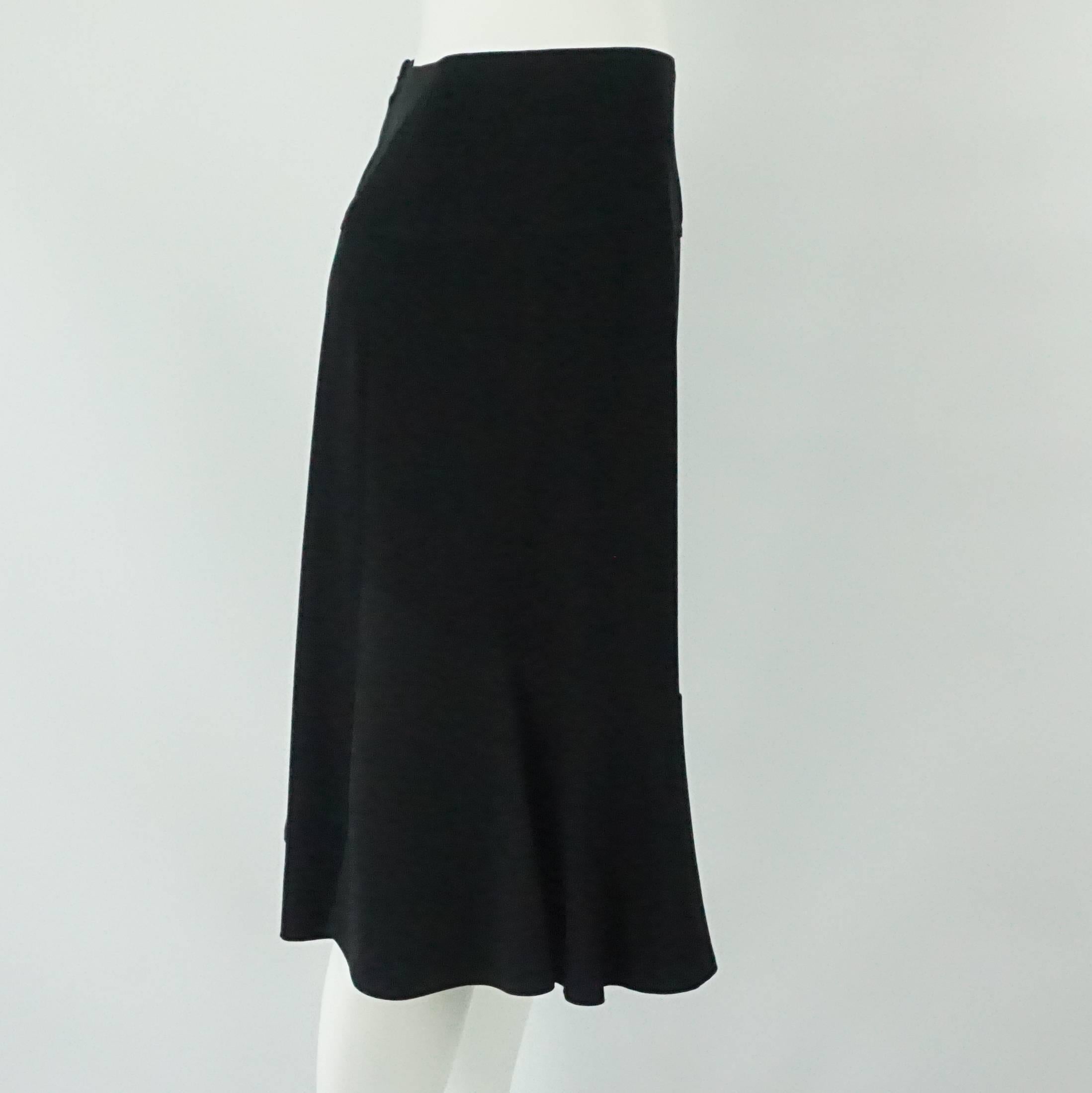 Chanel Black Silk Skirt - 44. This Chanel skirt is made of black silk. It has a flowing structure. The skirt is in excellent condition and a size 44.
Measurements
Waist: 29