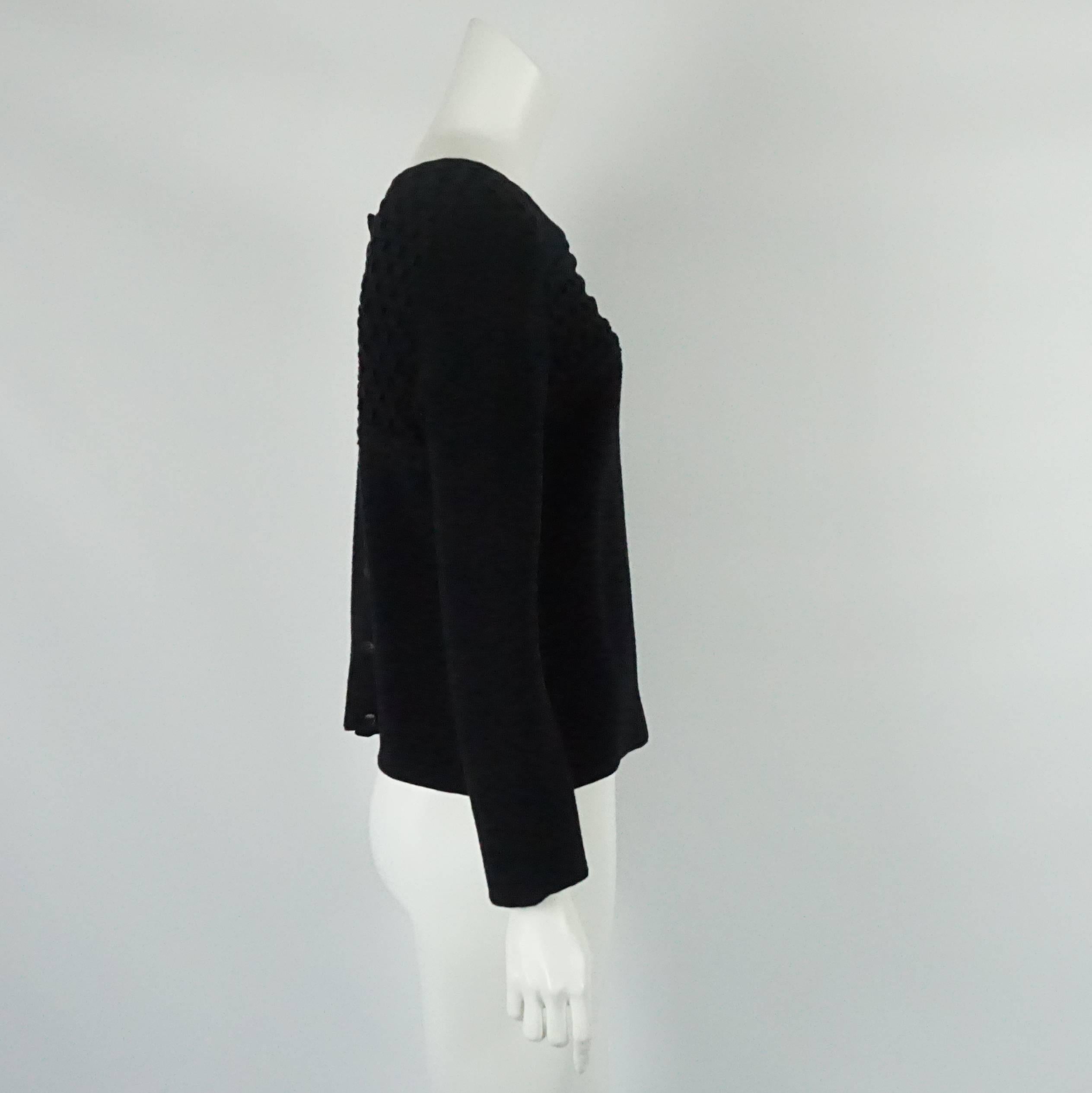 Chanel Black Wool Blend Ribbed Sweater Top - 40. This sweater is a beautiful piece for the cold weather. It is a wool, rayon, and camel hair blend and is in excellent condition with light wear. The sweater is fully ribbed with the neckline area