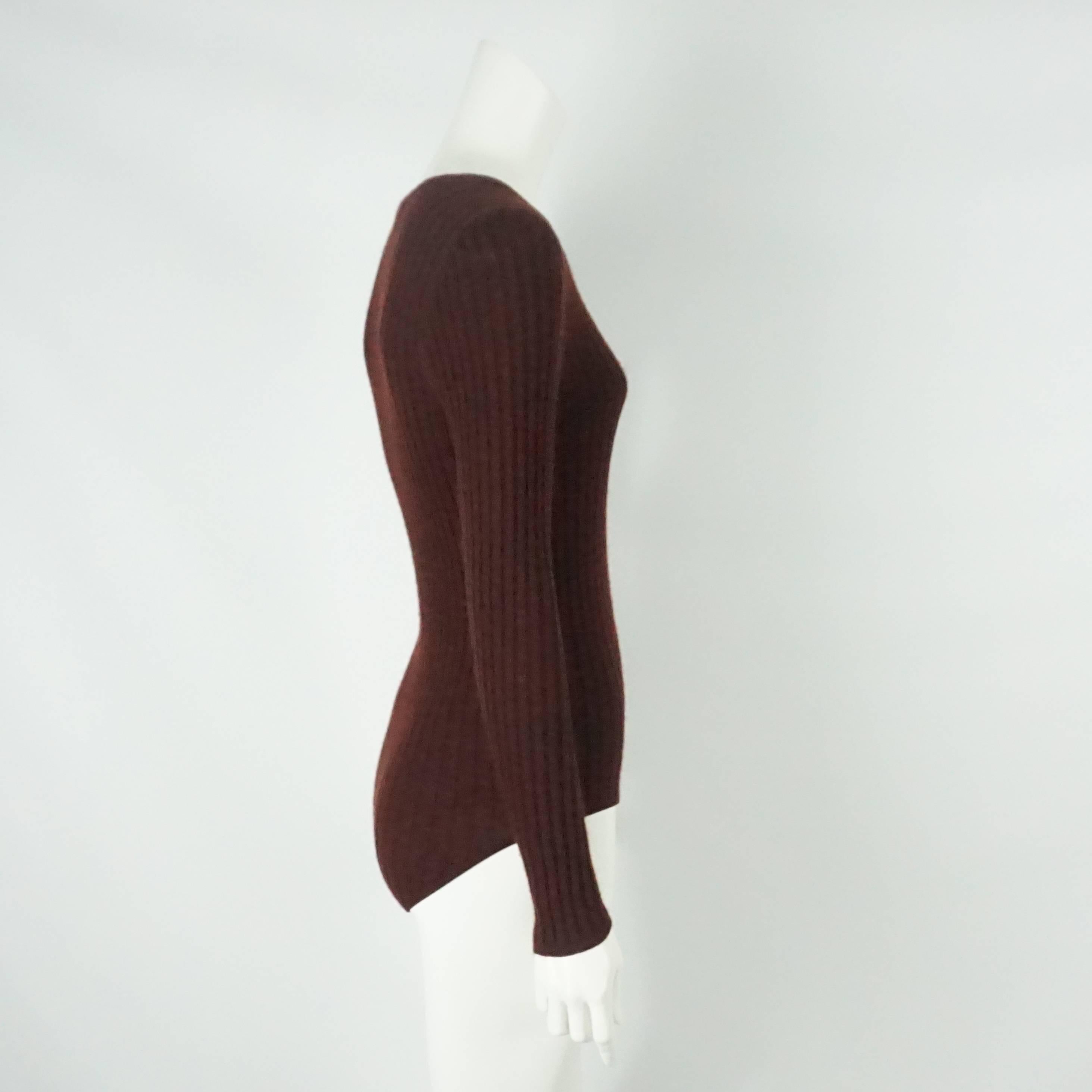 Chanel Burgundy Cashmere/Silk Blend Ribbed L/S bodysuit - 44 - Circa 97A  This bodysuit has a round neck, ribbed sweater style with long sleeves and a stitched CC on bottom left, 3 snaps in the crotch area. This item is in excellent vintage