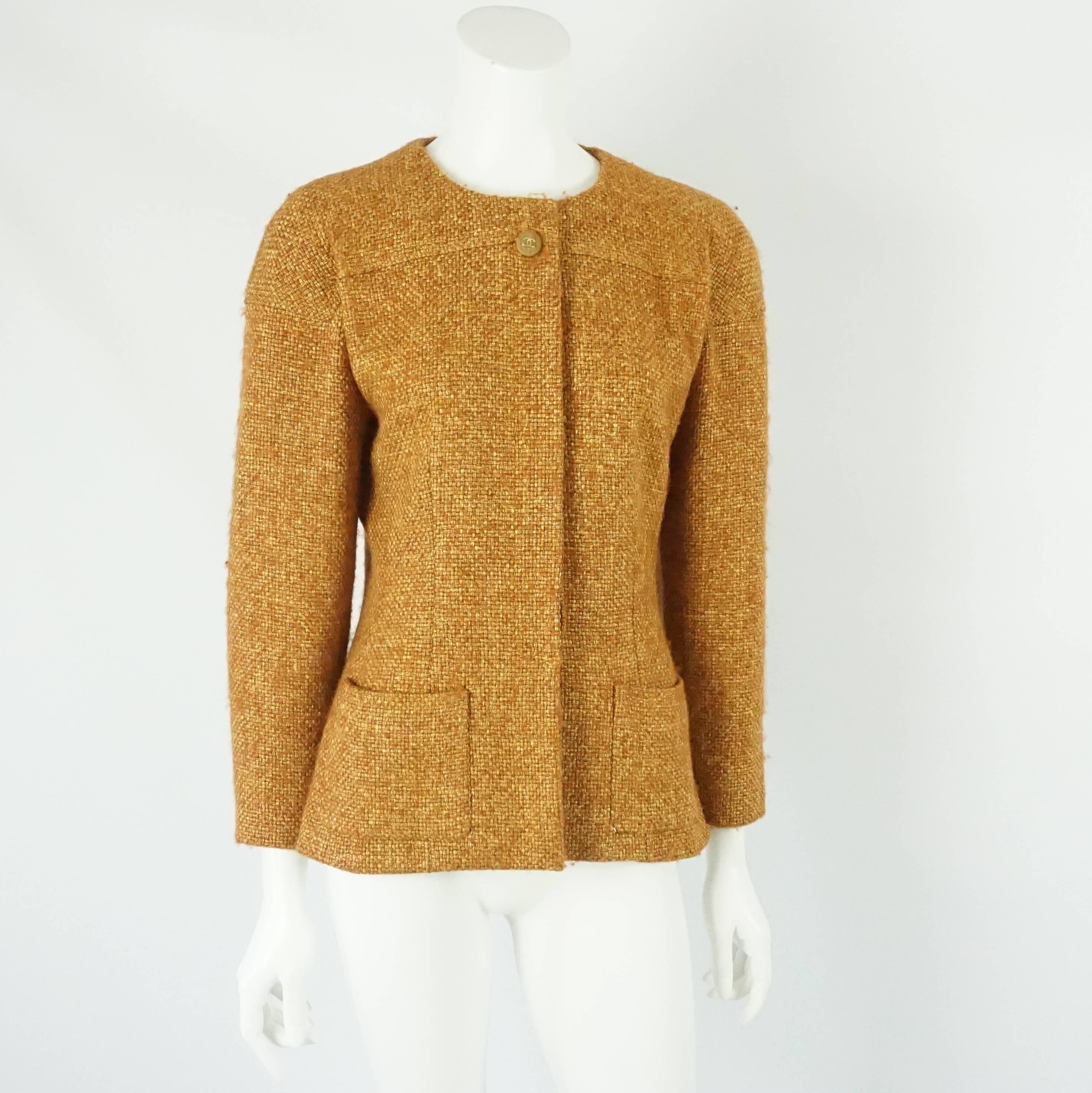 Chanel Burnt Orange Wool Blend Jacket with Removable Scarf/Tie - 38 - 01A. This jacket is a light burnt orange color. It has 2 front pockets at the bottom and 4 wooden 