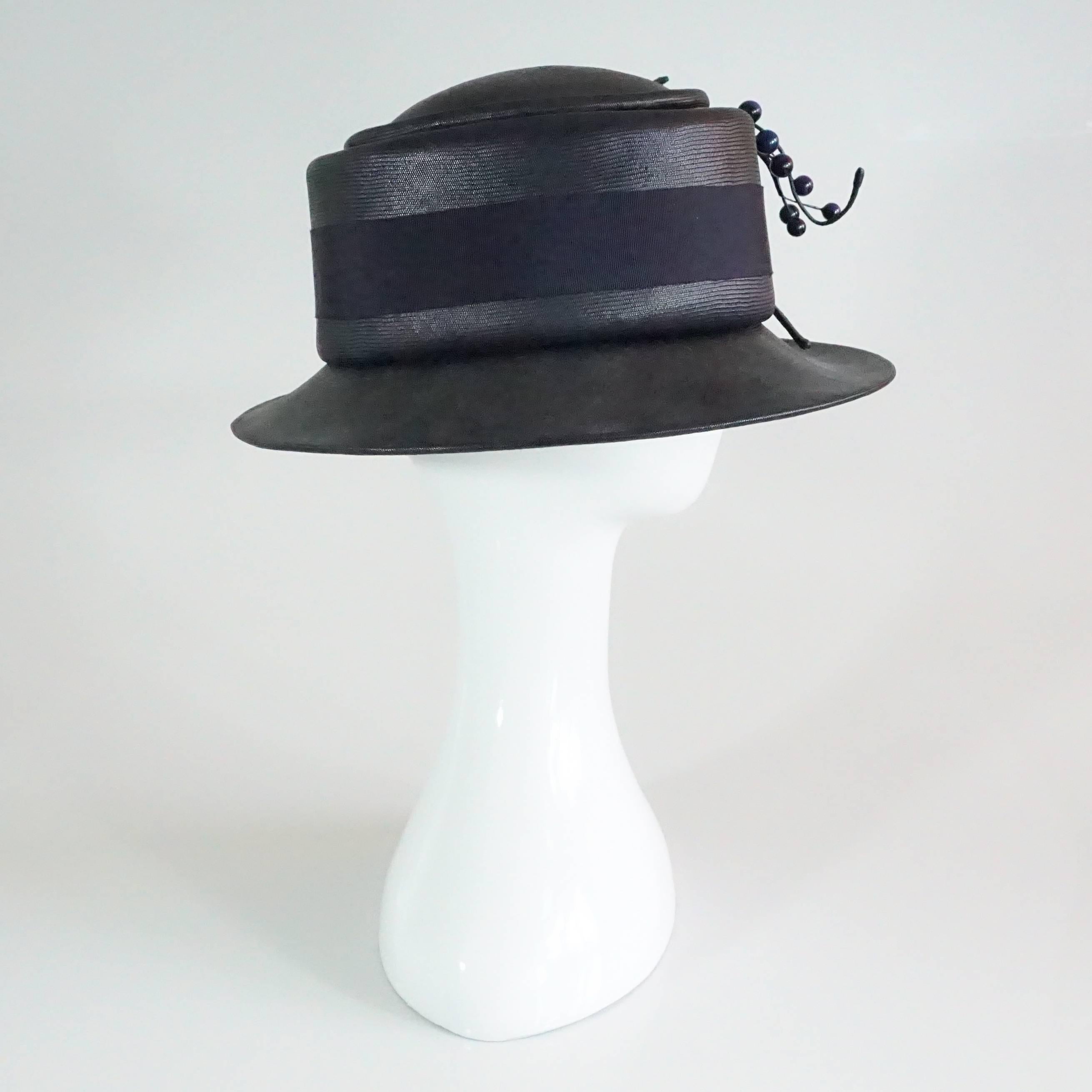 Suzanne Couture Millinery Black & Navy French Straw Hat w/ Ribbon & Bead detail. This hat is in excellent condition.
Measurements:
Inside Circumference: 20.5