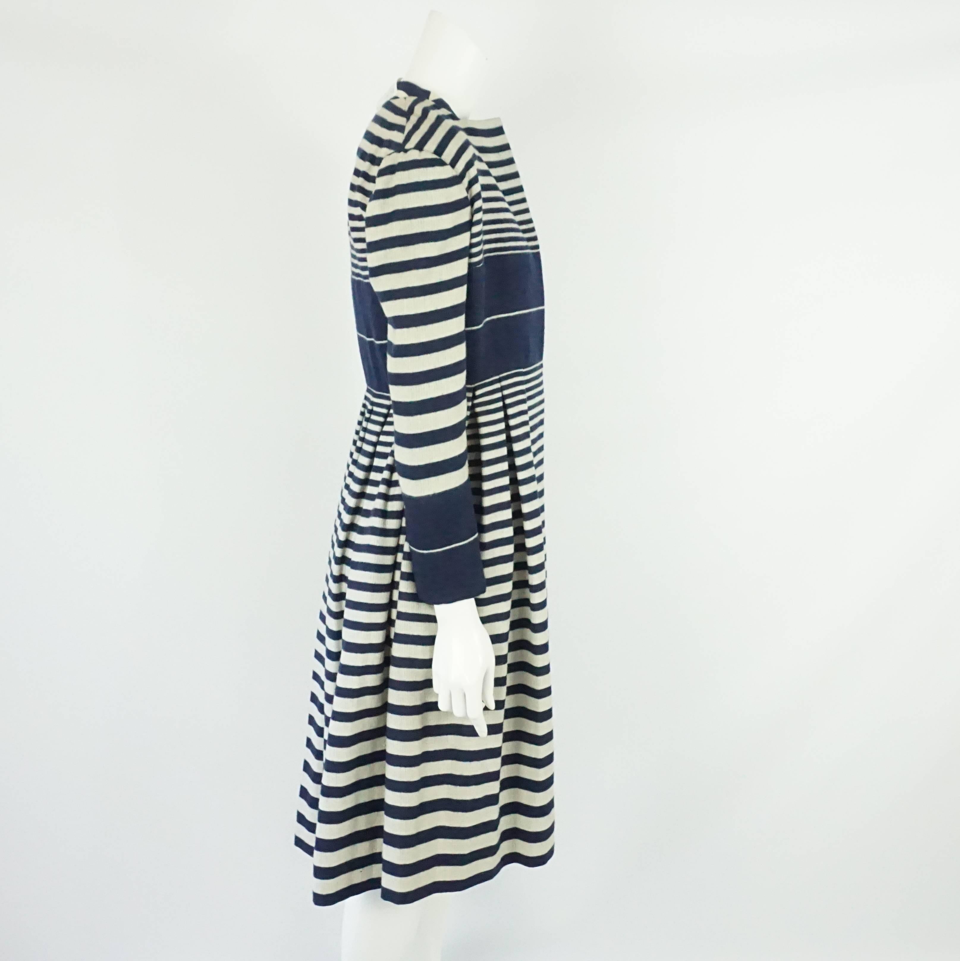 Pauline Trigere Navy and Ivory Striped Wool Dress, Coat, and Belt - 8- Circa 60s. This fun set features a striped, sleeveless dress with a silver metal charm on the front. The matching coat is fitted until the waist and then has pleats from the