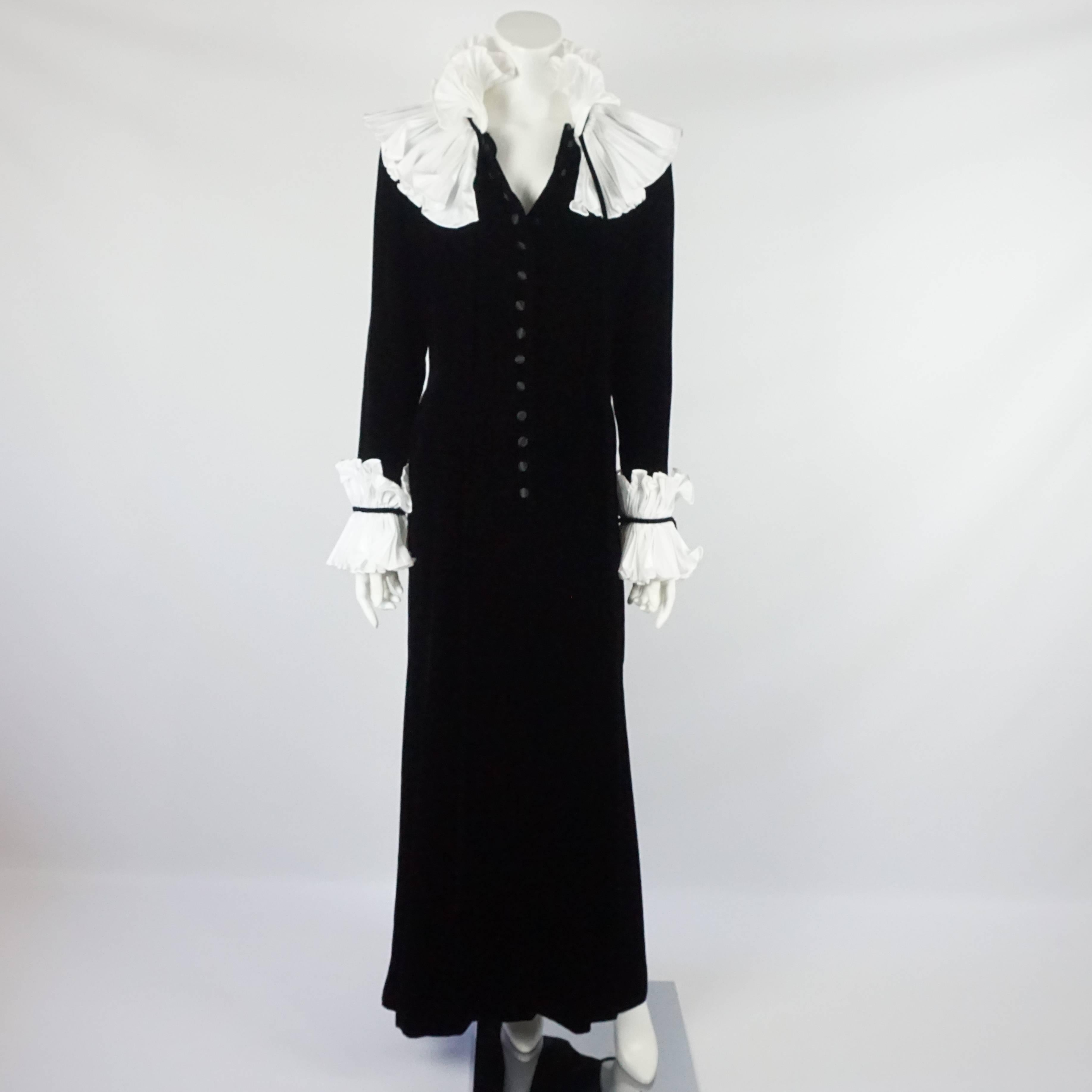 Oscar de la Renta Black and White Velvet and Silk Taffeta Gown - 12. Circa 90's. This unique gown is black with large white silk taffeta pleated collar and cuffs. The gown snaps down the front with faux buttons. There is also a velvet tie at the