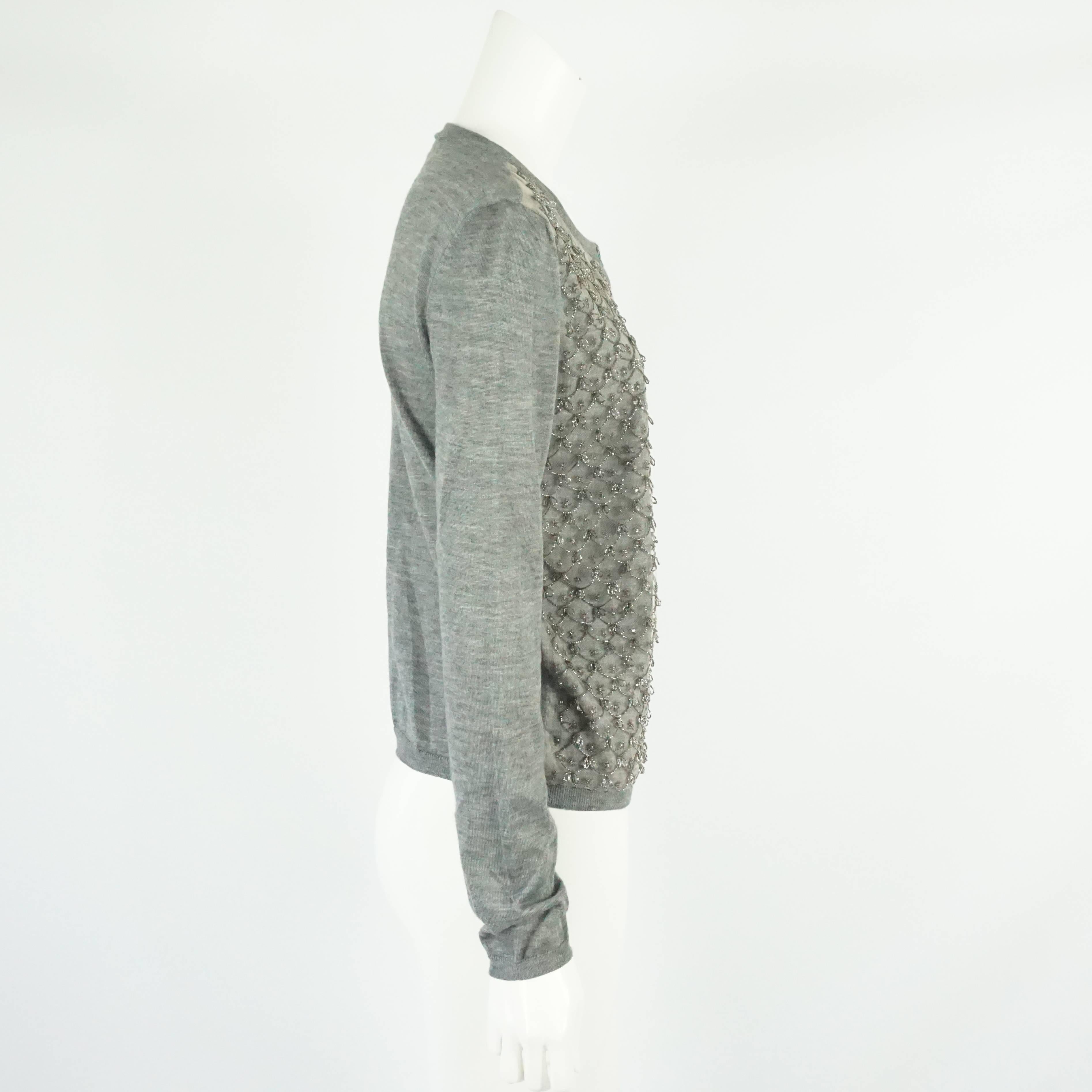 Valentino Gray Cotton-Knit Cardigan with Beaded Design - M. This beautiful and soft cardigan has a round neckline. The front of this cardigan has a mesh overlay with a scalloped beaded design, rhinestones, and beaded hanging loops. This cardigan is