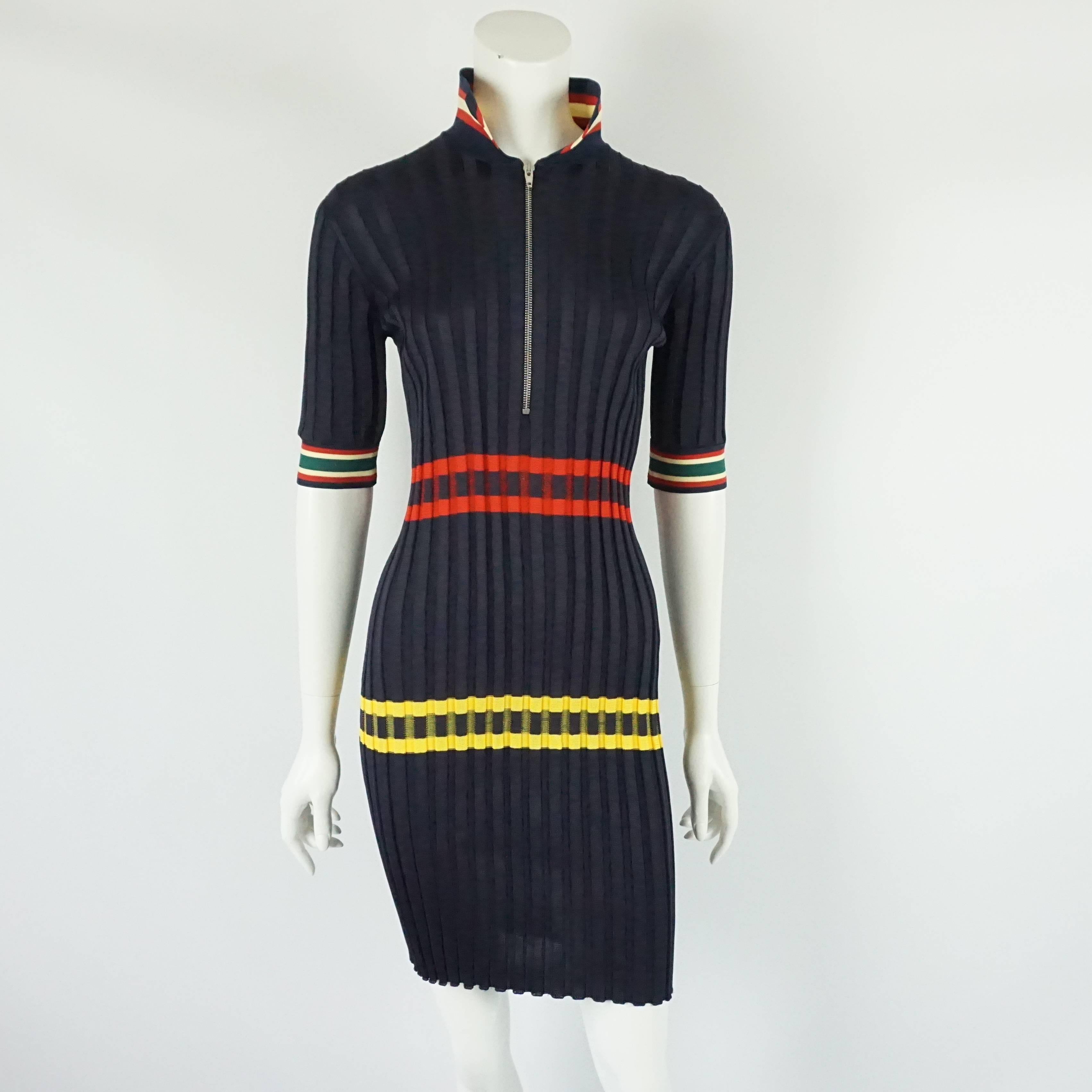 Celine Navy Knit Dress with Red and Yellow detail-XS This knit ribbed dress has a collar and cuff on sleeves that have red and yellow striped detail. The waist and hip area also have striped detail. It has a front silver zipper. The dress is in