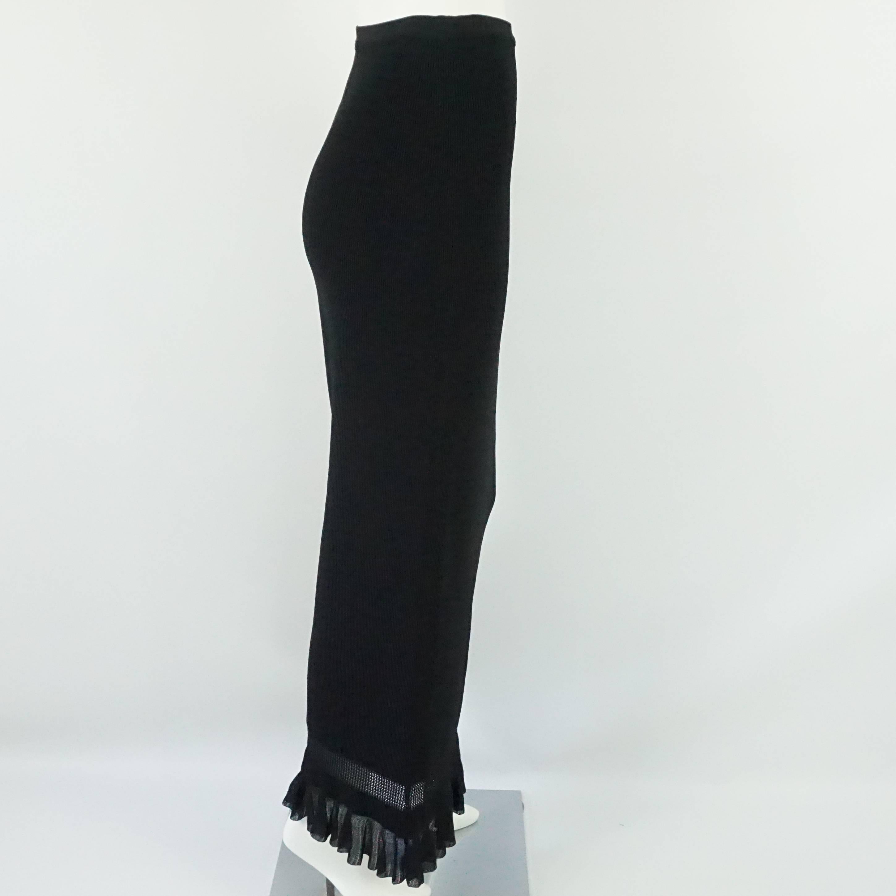 Alaia Black Knit Long Skirt w/ ruffle bottom-38  This fabulous and classic Alaia long knit skirt is in excellent condition. It has an elastic waistband and the bottom section of the skirt is a crochet style knit ruffle. 
Measurements:
Waist: