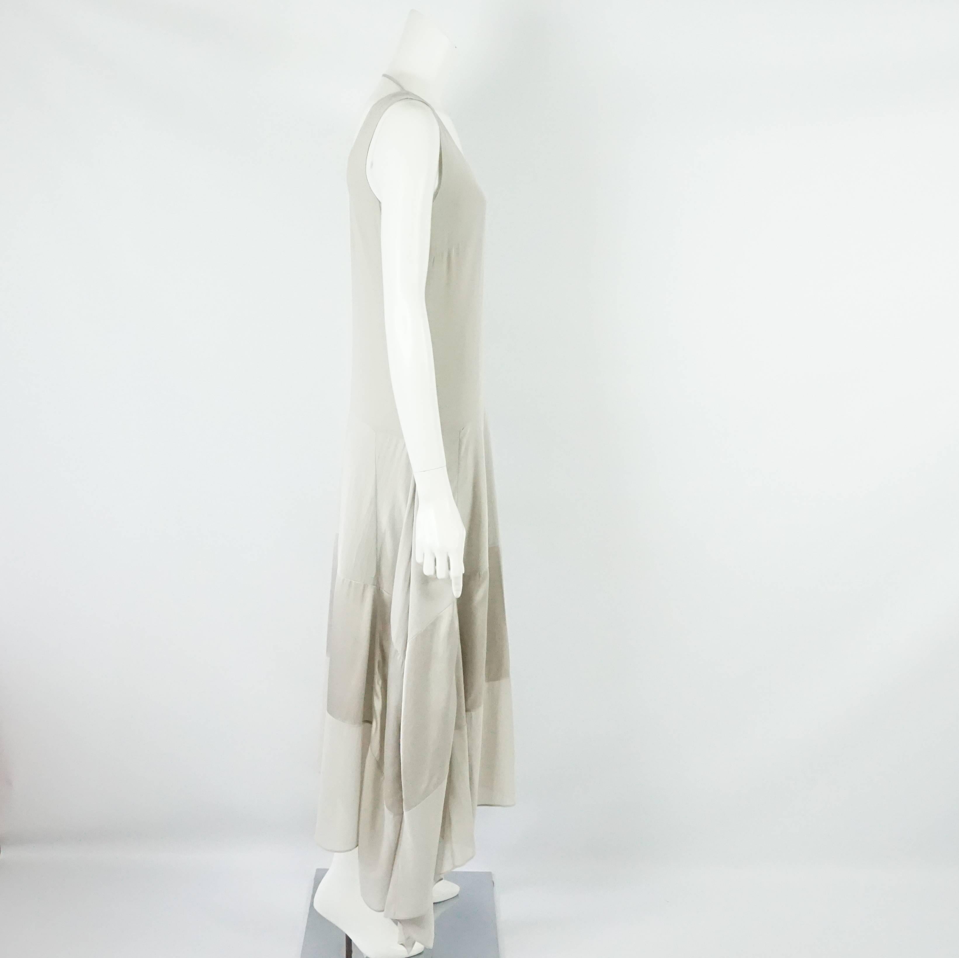 Brunello Cucinelli Taupe Silk Sleeveless Maxi Dress - Small  This beautiful maxi silk dress has 2 tones of taupe, it is sleeveless tank style and has a hemline that is longer on the sides. This dress is in excellent condition.
Measurements:
Bust :