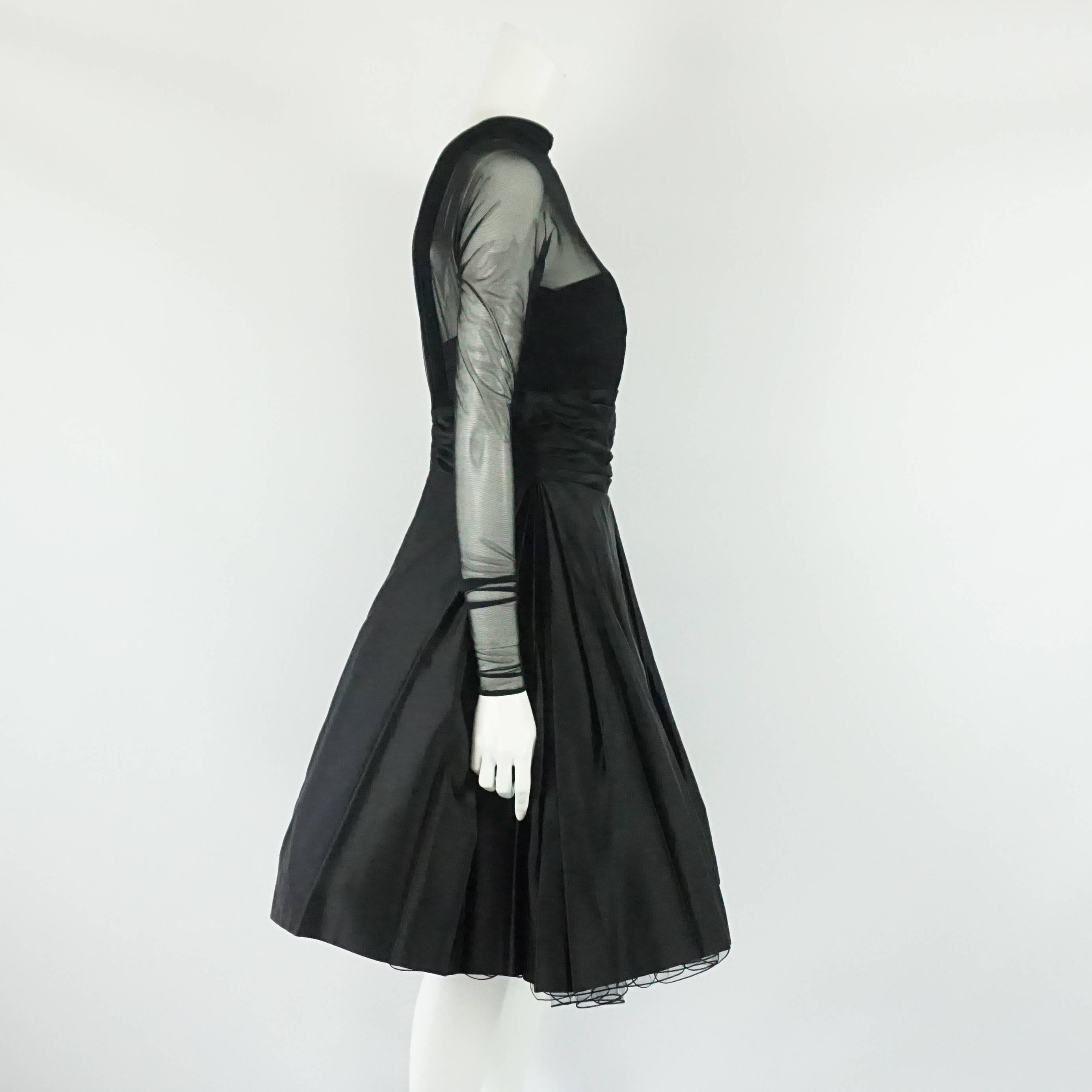 Vicky Tiel Couture Black Mesh and Acetate Evening Dress - 42 - Circa 80's This elegant and classy black vintage dress is fitted to the waist with a sweetheart neck acetate underskirt section and a top mesh long sleeve layer along the top of the