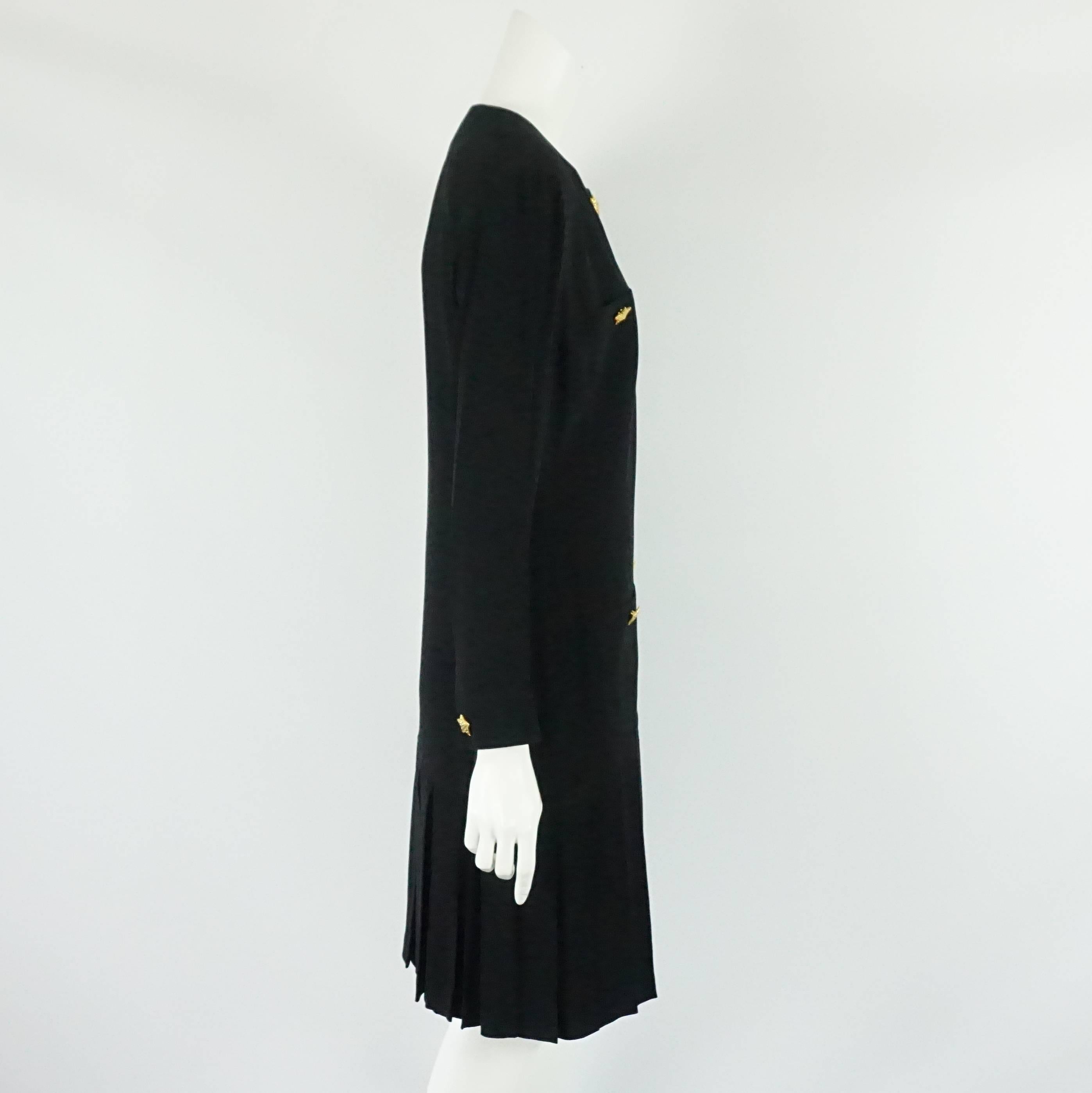Escada by Margaretha Ley Black Shift Dress with bottom pleating-40 Circa 80's This classic piece has long sleeves with wrist band and gold buttons, the bottom of the skirt is pleated, the front has 8 gold star buttons giving it a bit of a coat dress