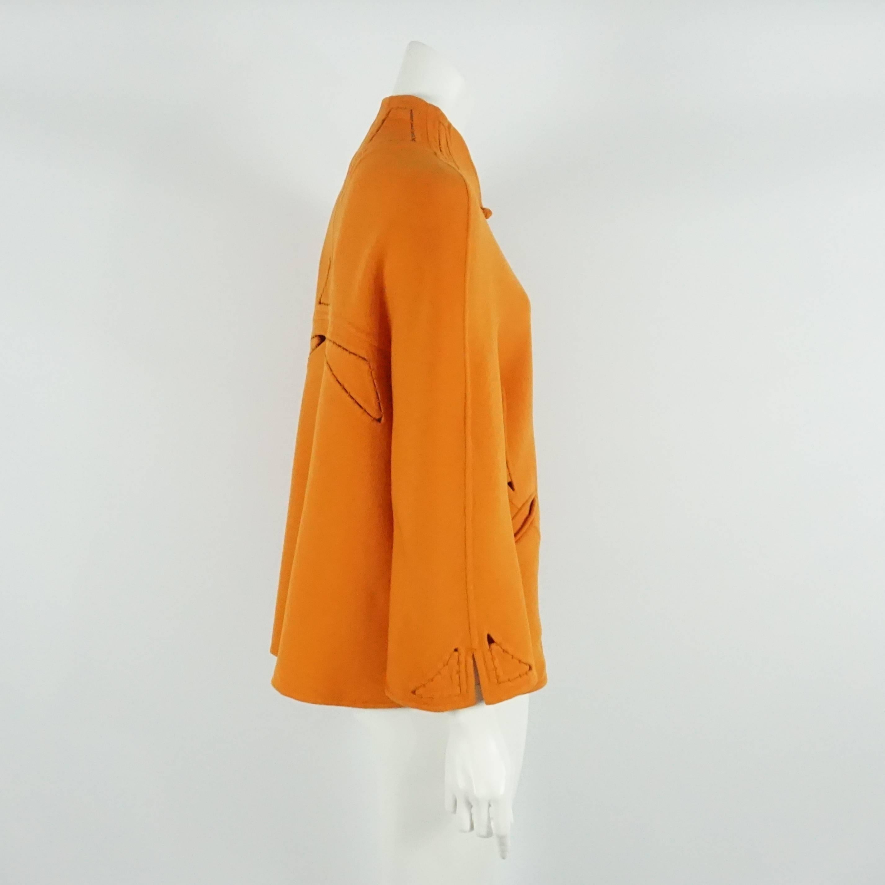 Chado Ralph Rucci Orange Cashmere Cutout Jacket - 6  This fabulous jacket is   made of a thick soft cashmere, with cutouts throughout w/ hand stitching, 2 front pockets, and 6 front buttons. This jacket is in excellent