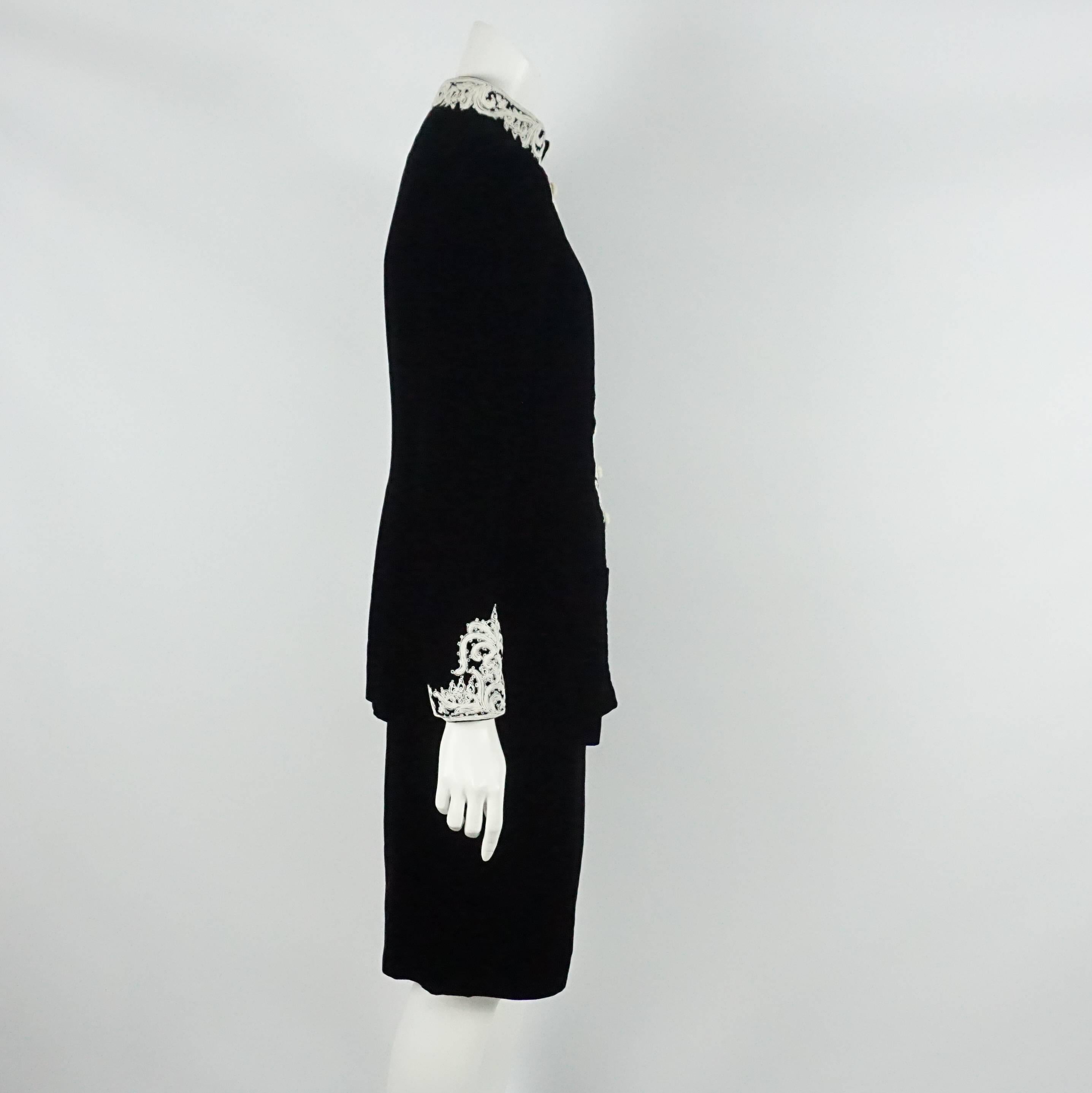 Oscar de la Renta Black Velvet Skirt Suit with White Embroidery - 10 - 1990s. This skirt suit is in excellent vintage condition with light wear to the velvet and embroidery. The jacket features an oriental collar, an embroidered trim, shoulder pads,