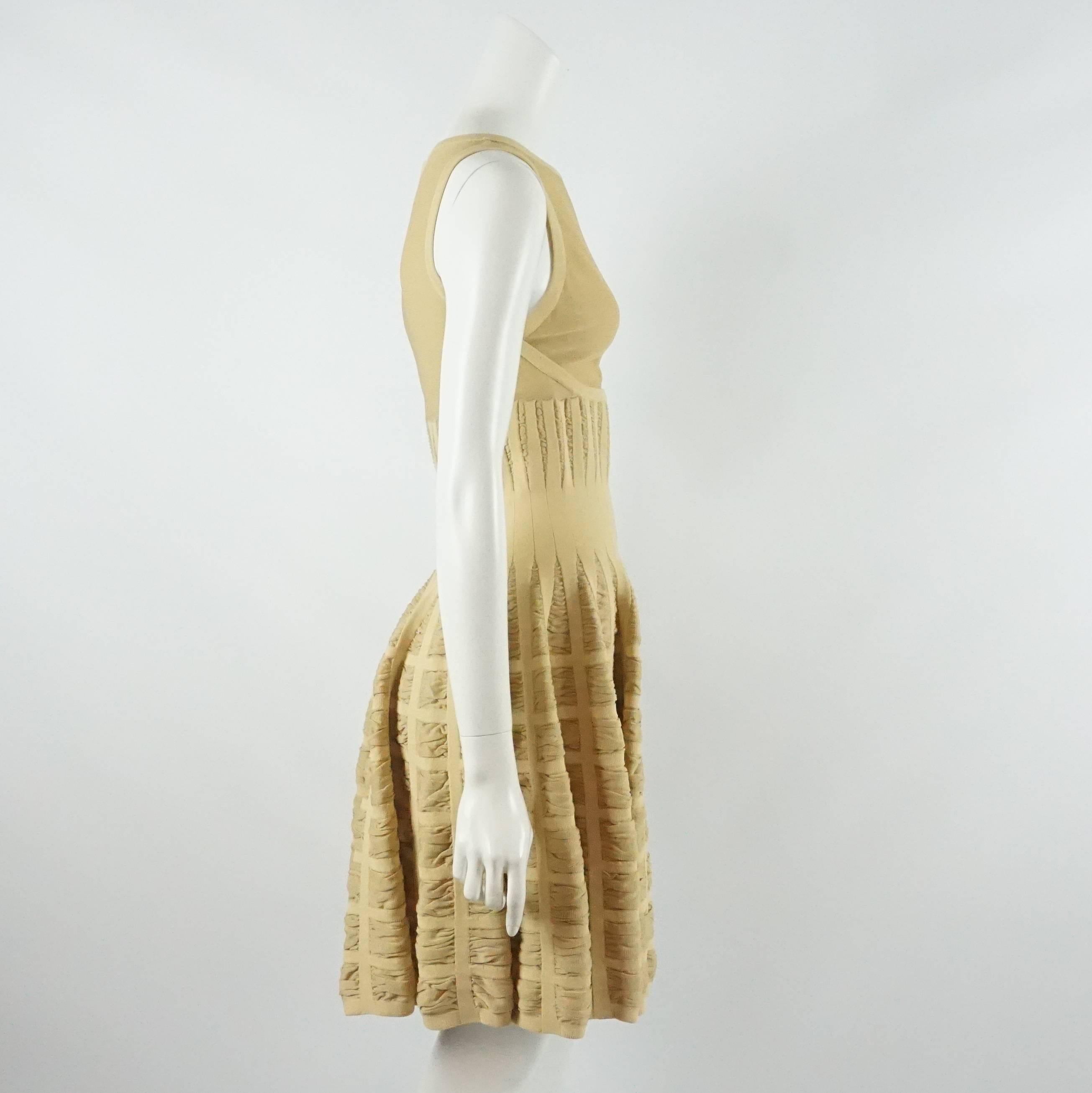Alaia Camel Silk Knit Sleeveless Flare Dress - 40. This sleeveless scoop neck silk knit blend dress is a pretty camel color. The top bodice is mesh, and the rest of the dress has a textured knit look to it and is fitted to the waist and flares out