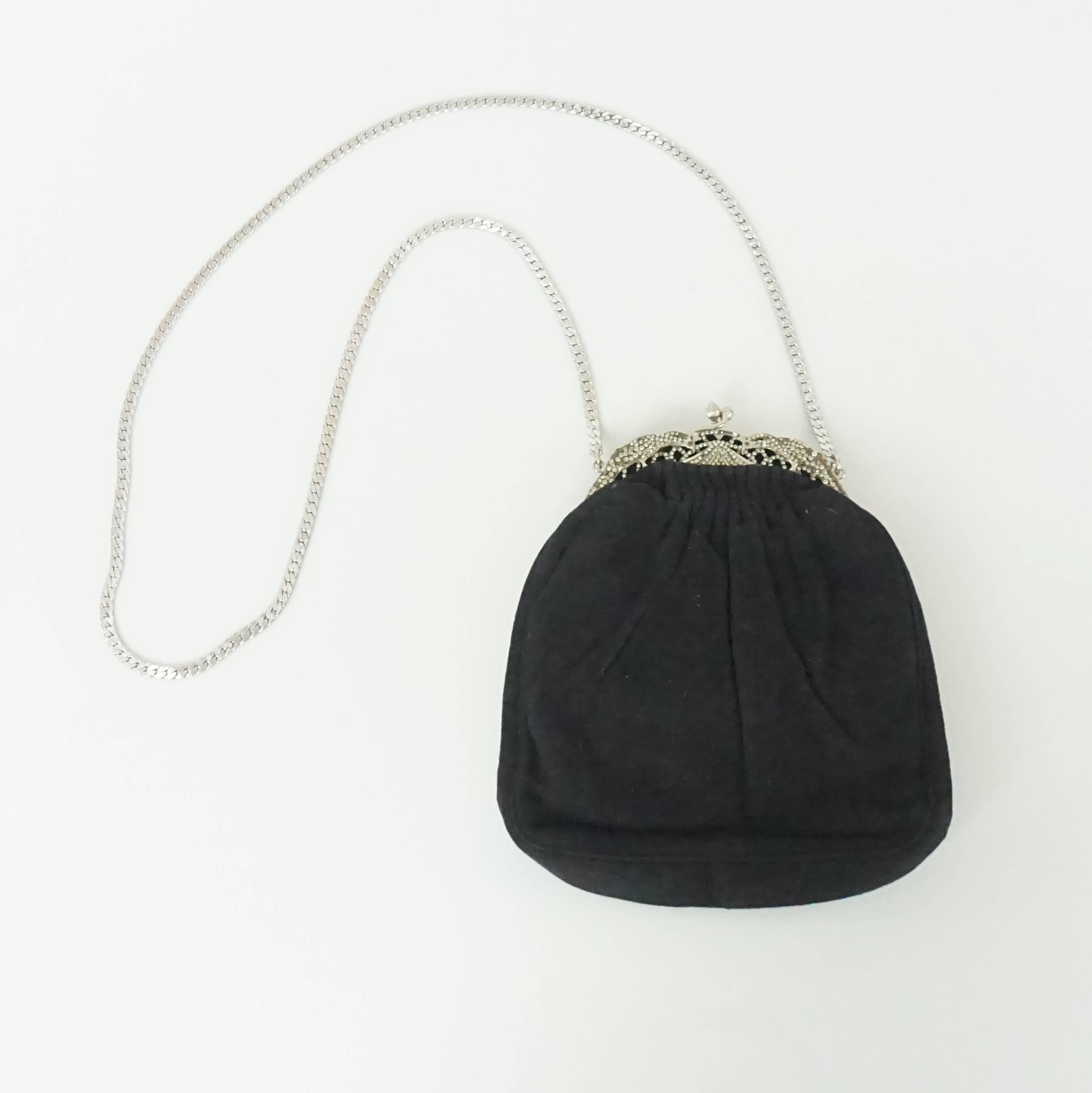 Judith Leiber Black Suede Rhinestone Evening Bag. This beautiful piece mixes new with vintage trends. It is in fair vintage condition with some wear to the suede and rhinestones on the top being missing. The bag has a black satin lining and a silver