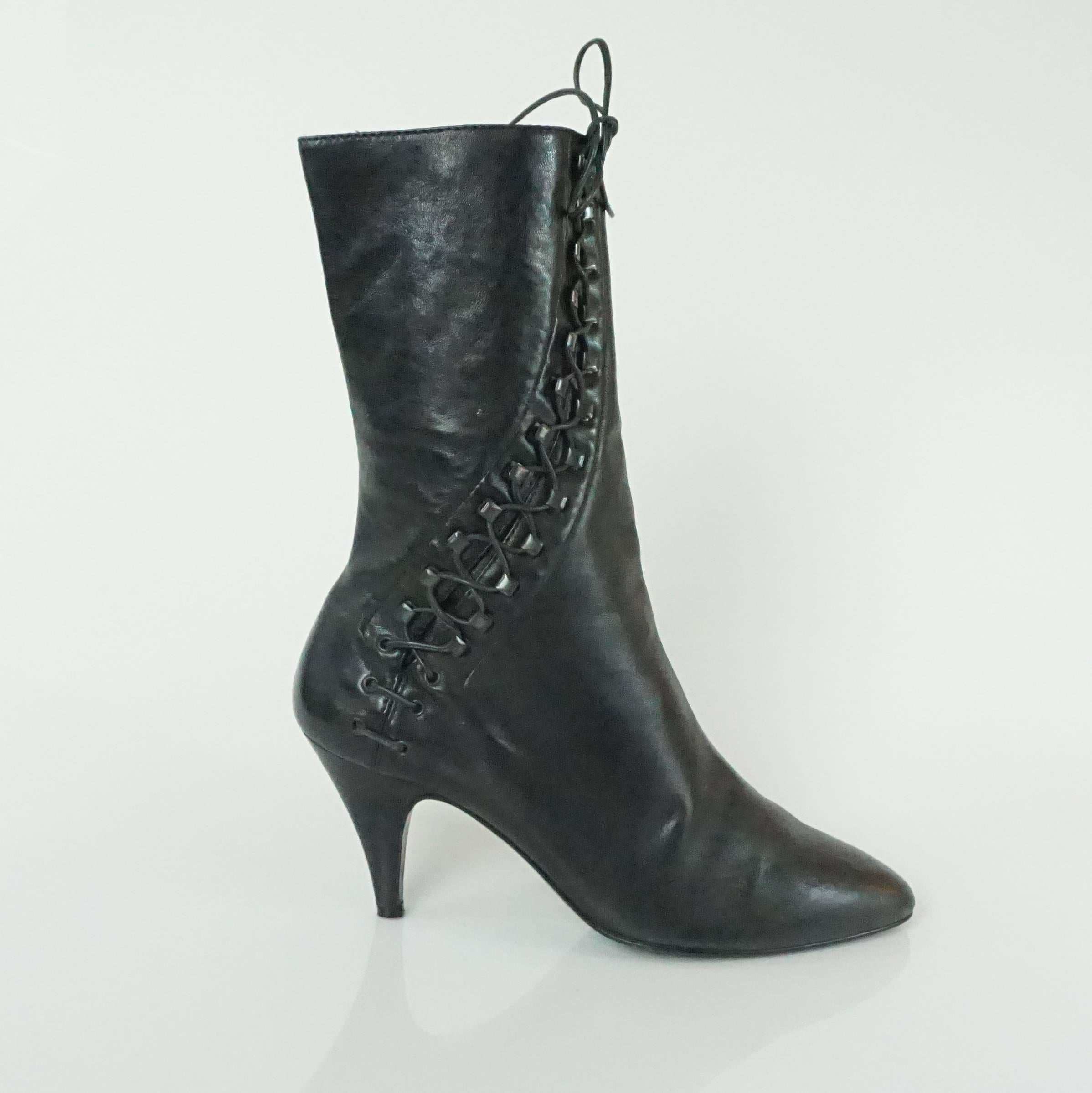 Azzedine Alaia Black Lambskin Boots with Lace-Up Sides - 37.5 - 1990's. These gorgeous boots are a hot find for fall. They are mid-calf length with black stud-like lace-up sides. They are in very good condition with light wear to the leather as