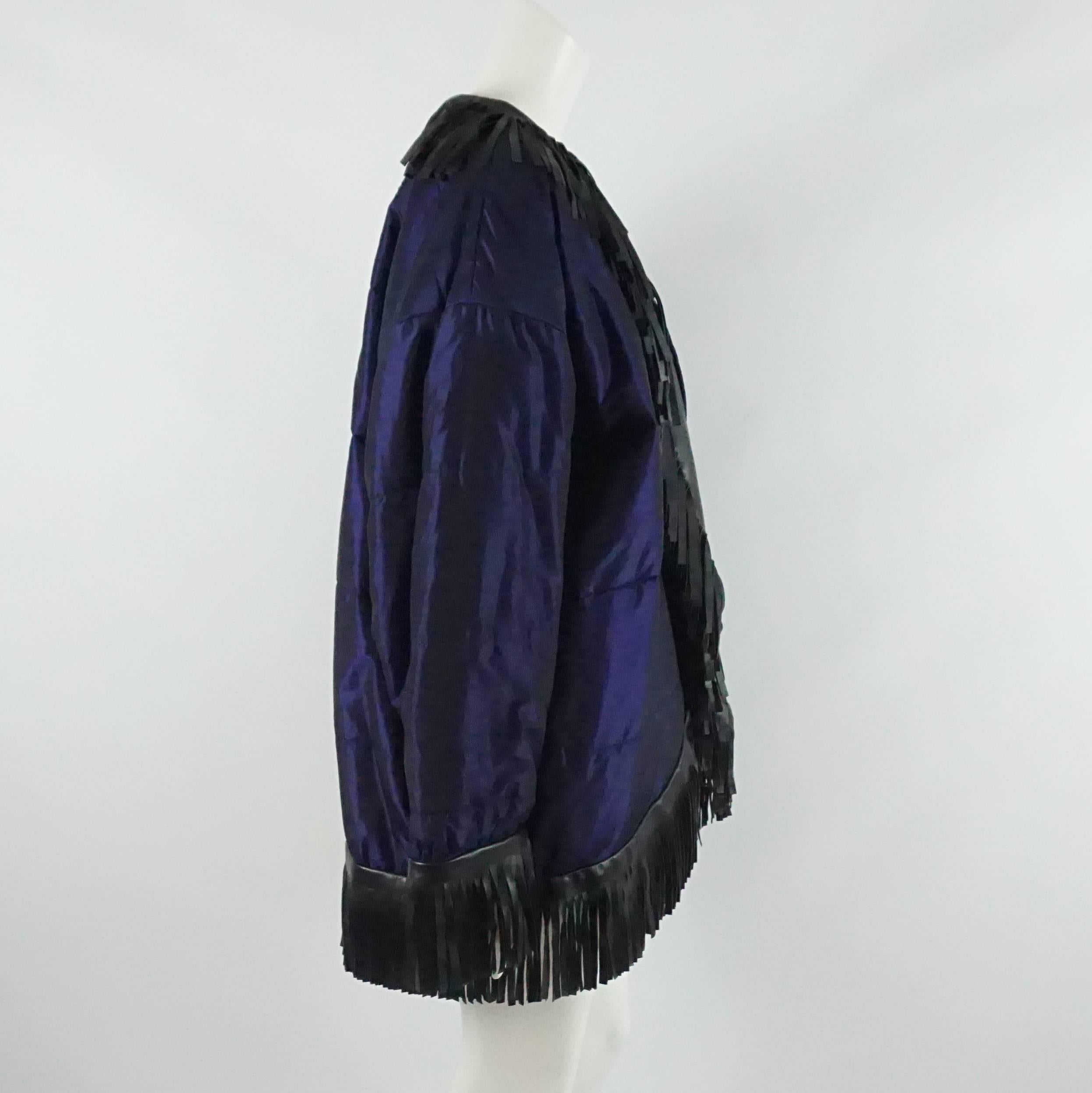 YSL Blue Puffer Coat with Black Fringe Trim - 40 - 1980's. This piece is truly spectacular and a great way to spice up a winter outfit. The jacket is has a blue-purple hue with a slight sheen. It features a leather fringe trim, shoulder pads, and an