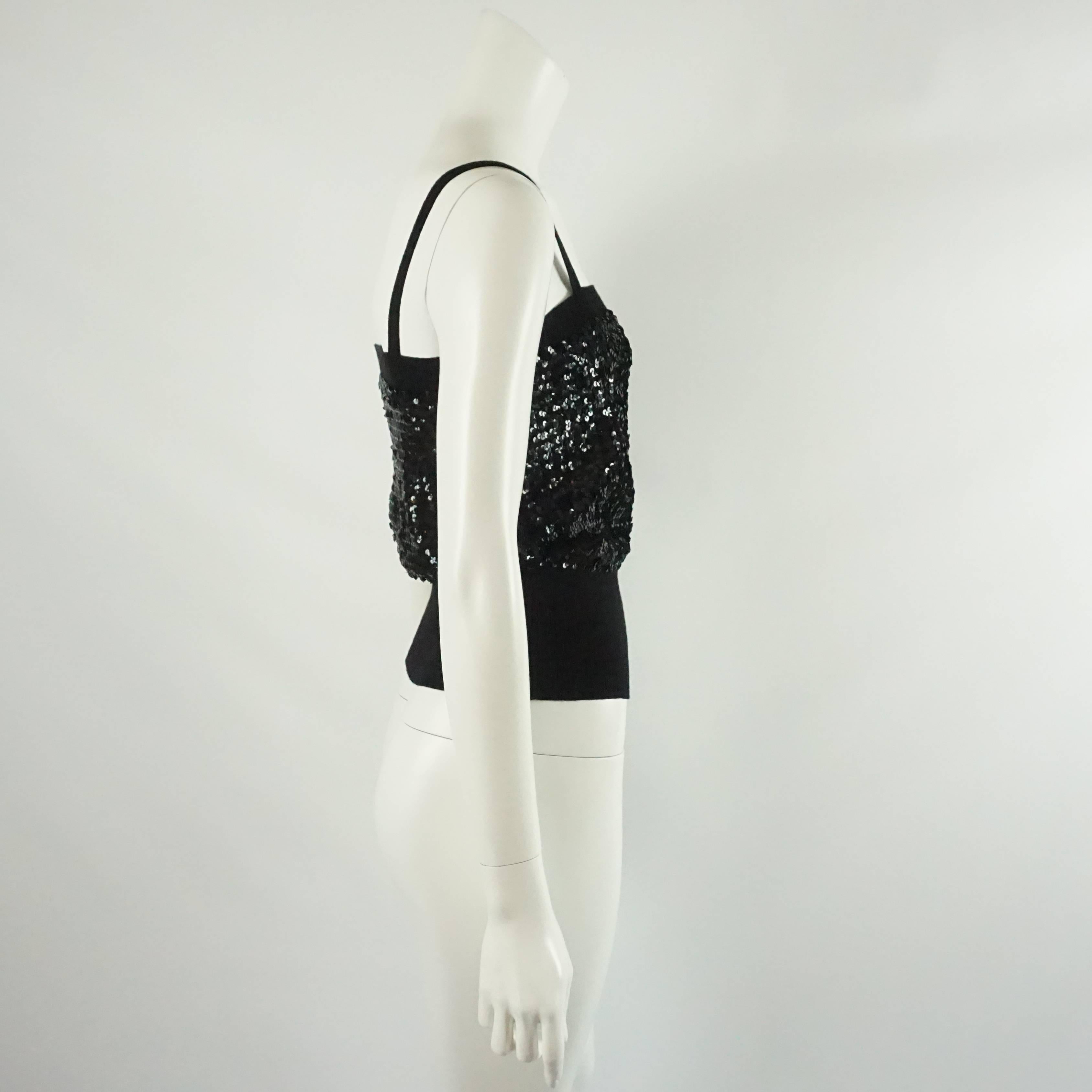 YSL Black Sequin and Wool Tank Top - M - 1980's. This top is a perfect piece for the holiday season. It has spaghetti straps, a sequin filled bodice, and a stretch wool bottom. The top is in good vintage condition with light wear.