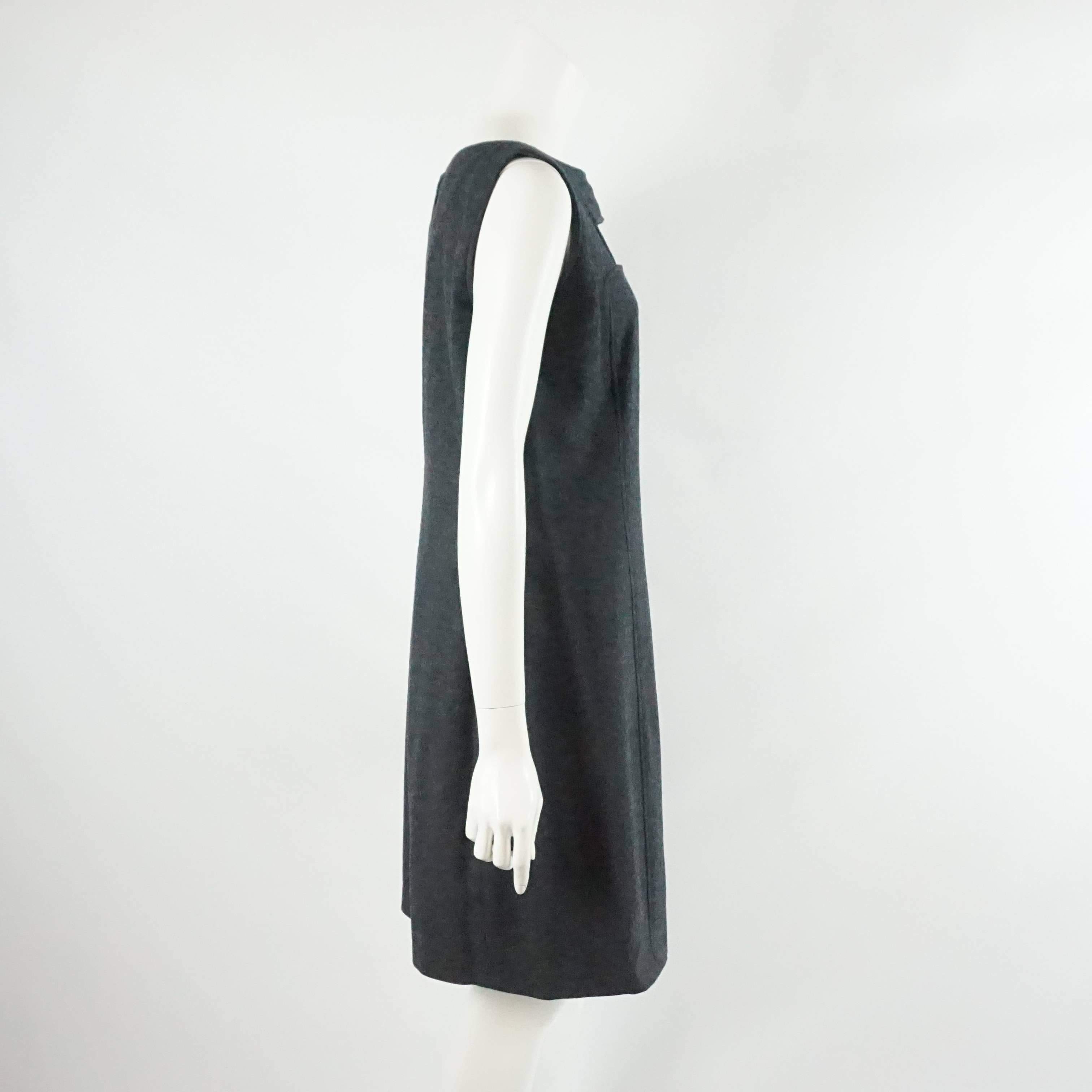 This Oscar de la Renta wool shift dress is a charcoal color. It is sleeveless and has a cutout in the front. This dress is in excellent condition.

Measurements
Bust: 39