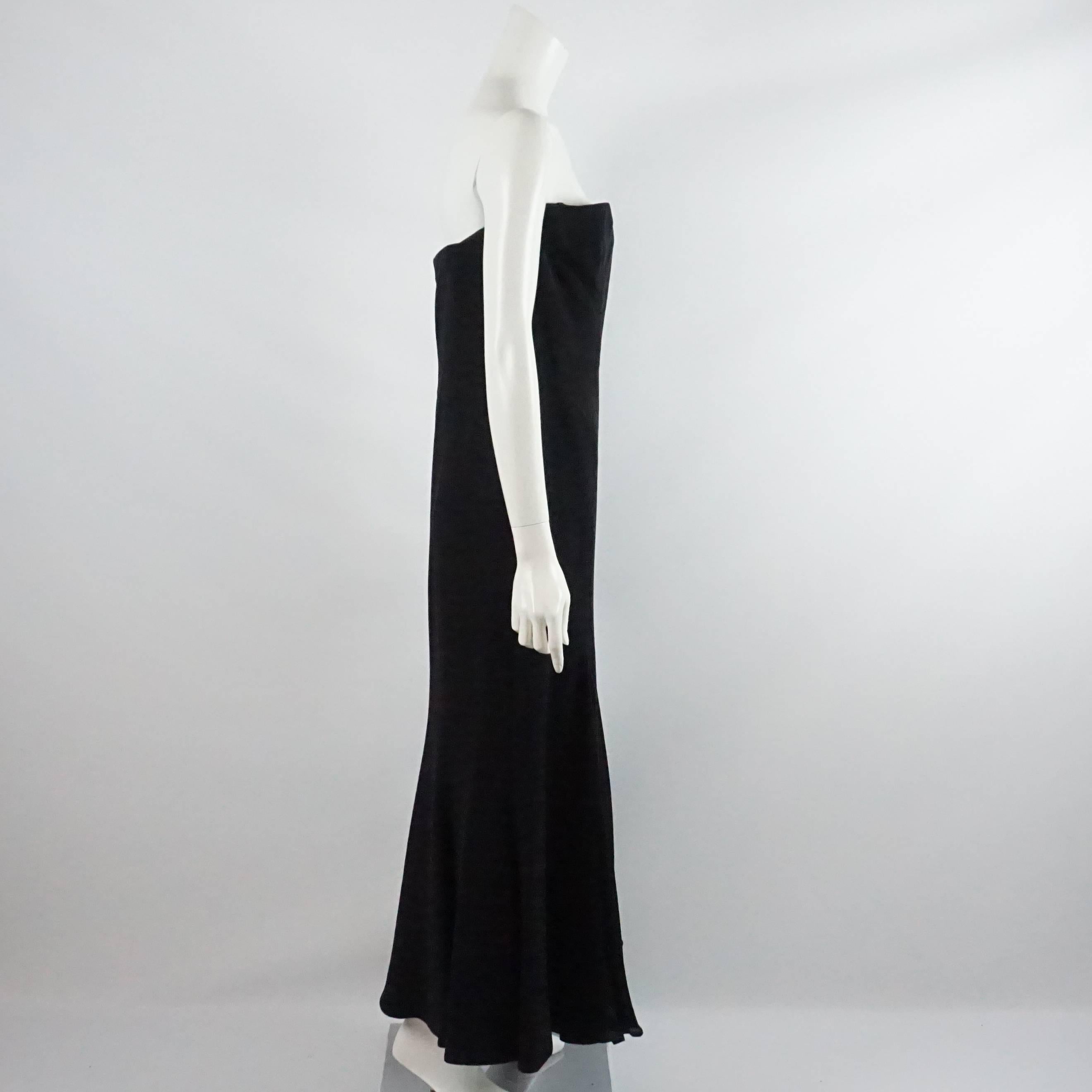 This Giorgio Armani black silk gown is strapless and has pleats. There is a back zipper. This dress is in excellent condition.

Measurements
Bust: 34