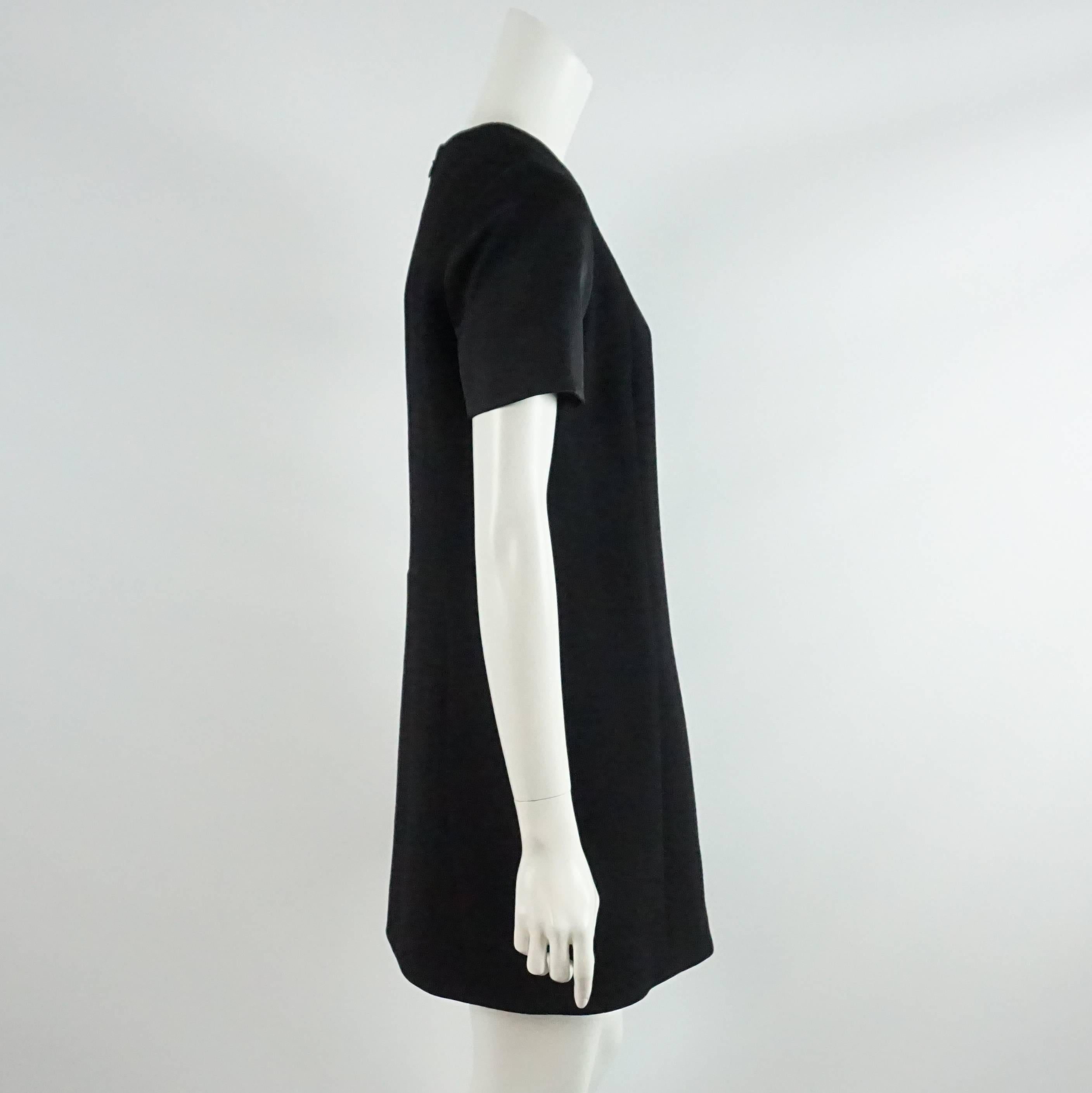 This black Celine dress is a great addition to any wardrobe. It is made of wool and has a shift cut with satin short sleeves. This dress is in excellent condition.

Measurements
Shoulder to Shoulder: 15