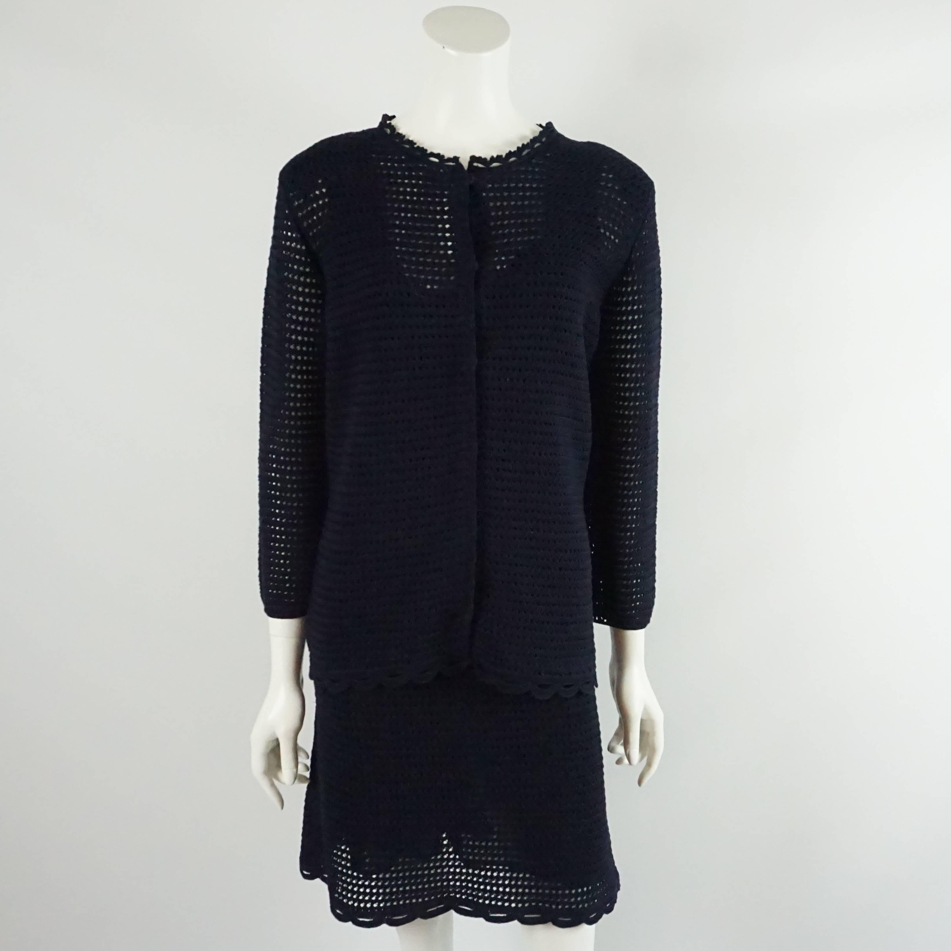 This navy Prada set comes with a thick crocheted dress and a matching long cardigan. The dress is sleeveless and comes with a black shell and both pieces have a scalloped trim. The set is in excellent condition.

Measurements

Dress
Bust: