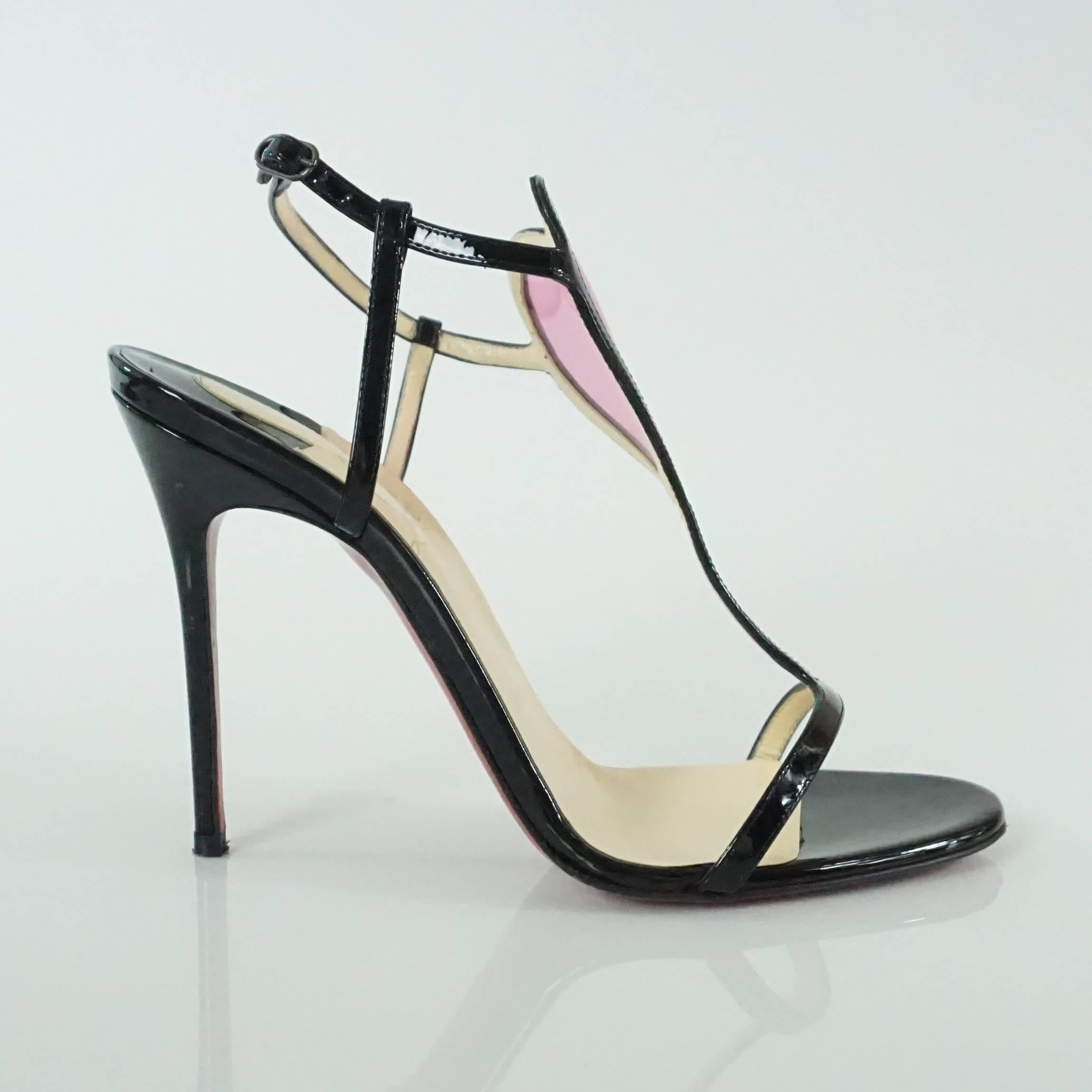 Christian Louboutin Black Patent and Pink PVC Cora Heart Heels - 37. These gorgeous heels have barely been worn and are in excellent condition. They have thin straps with a center heart and come with a duster and box. 

Heel Height: 4.25