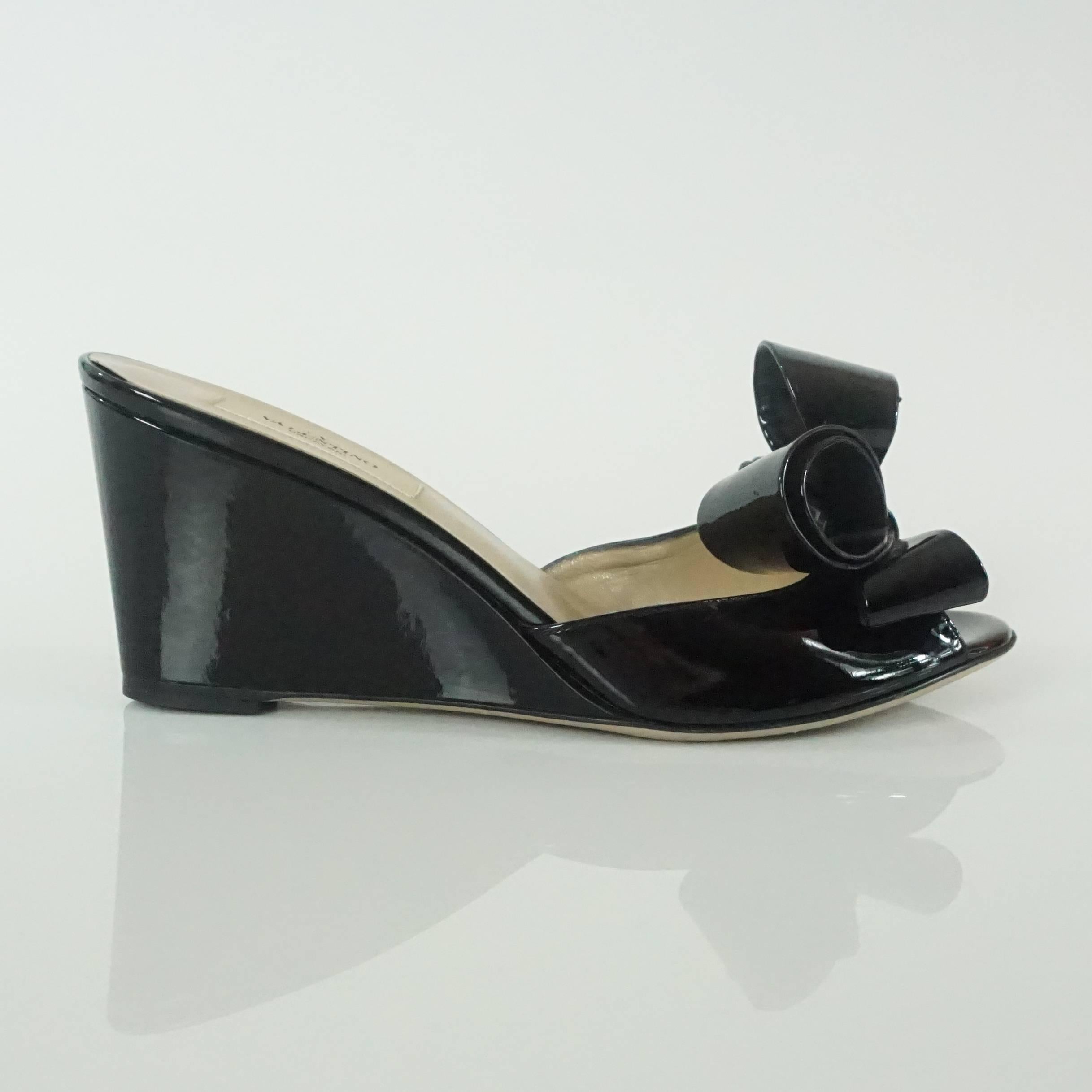 These Valentino black patent bow wedges are a beautiful classic! They are in excellent condition with with minimal wear to the bottom. These wedges come with the duster and box. 

Measurements
Wedge: 3