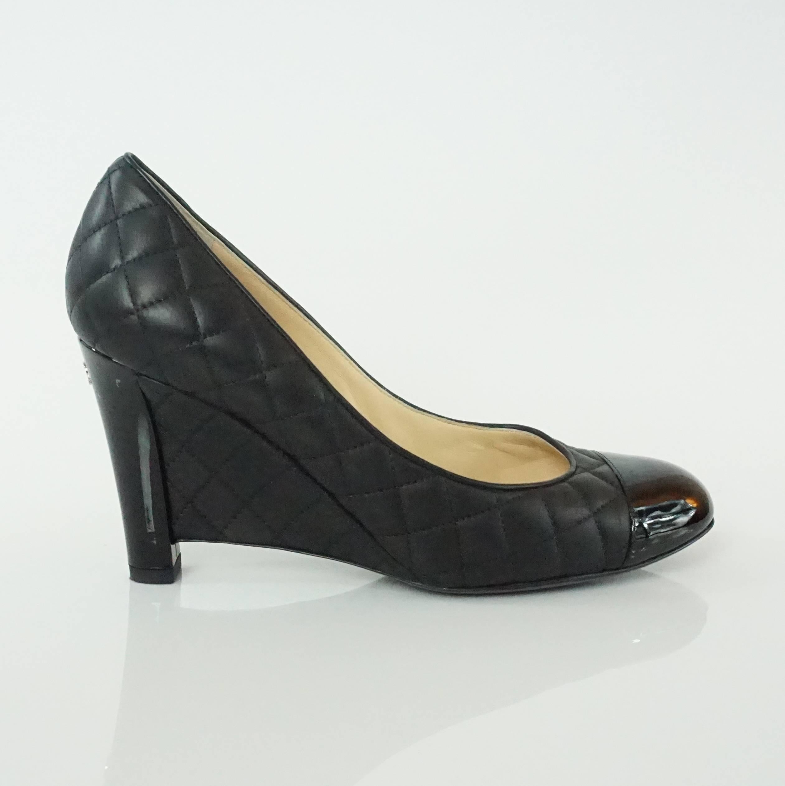 These Chanel black leather wedges are entirely quilted with a patent toe and heel with a 