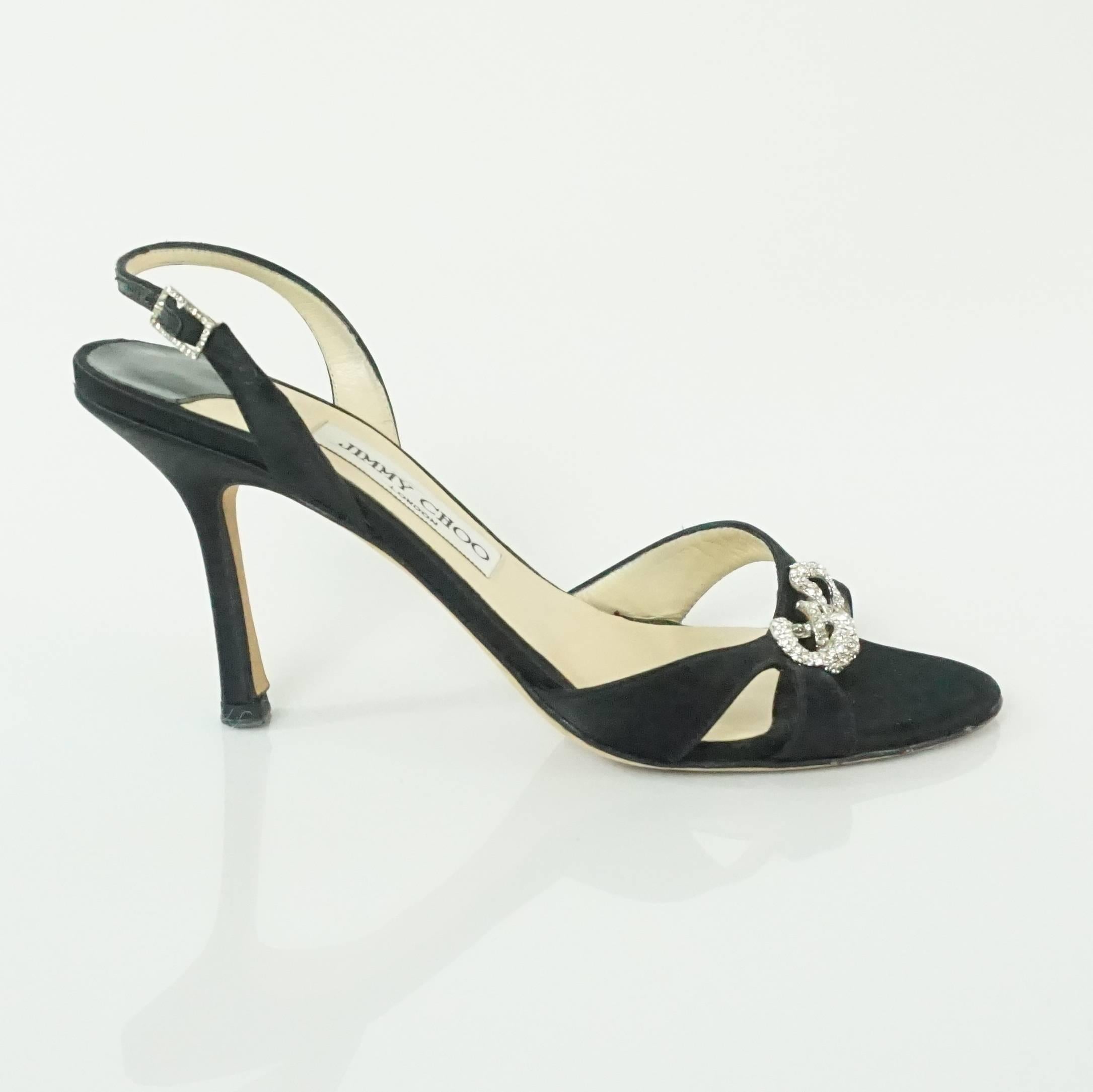 These Jimmy Choo black satin sandals have an open toe front with rhinestone links. They are in excellent condition with minimal bottom wear. The heels also come with a duster. 

Heel: 3.5