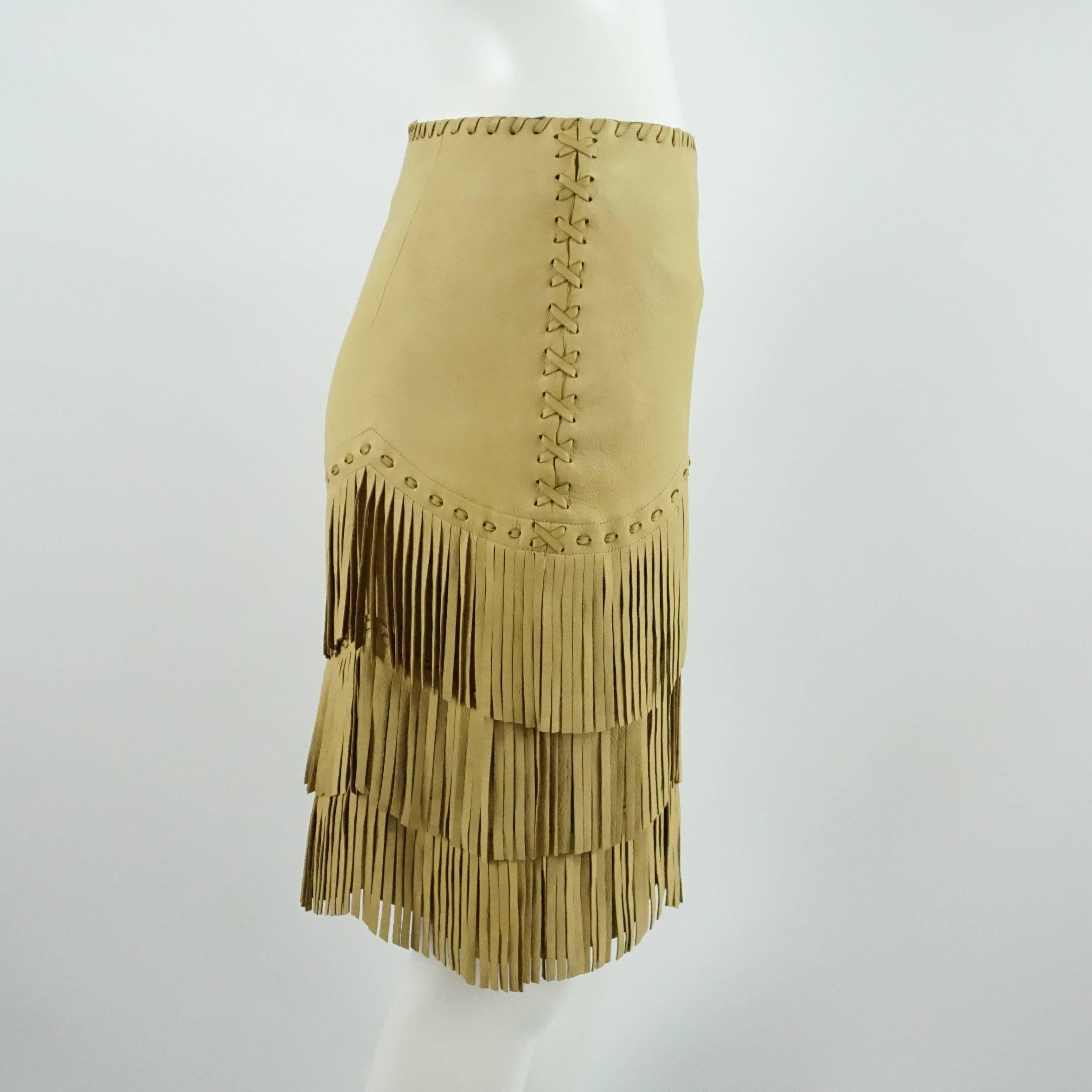 This Ralph Lauren Collection runway skirt is a fantastic piece from the 2011 collection. The leather piece has tiered fringe with a woven leather trim and wood-like buttons on the side. The skirt is in excellent condition with light wear on the
