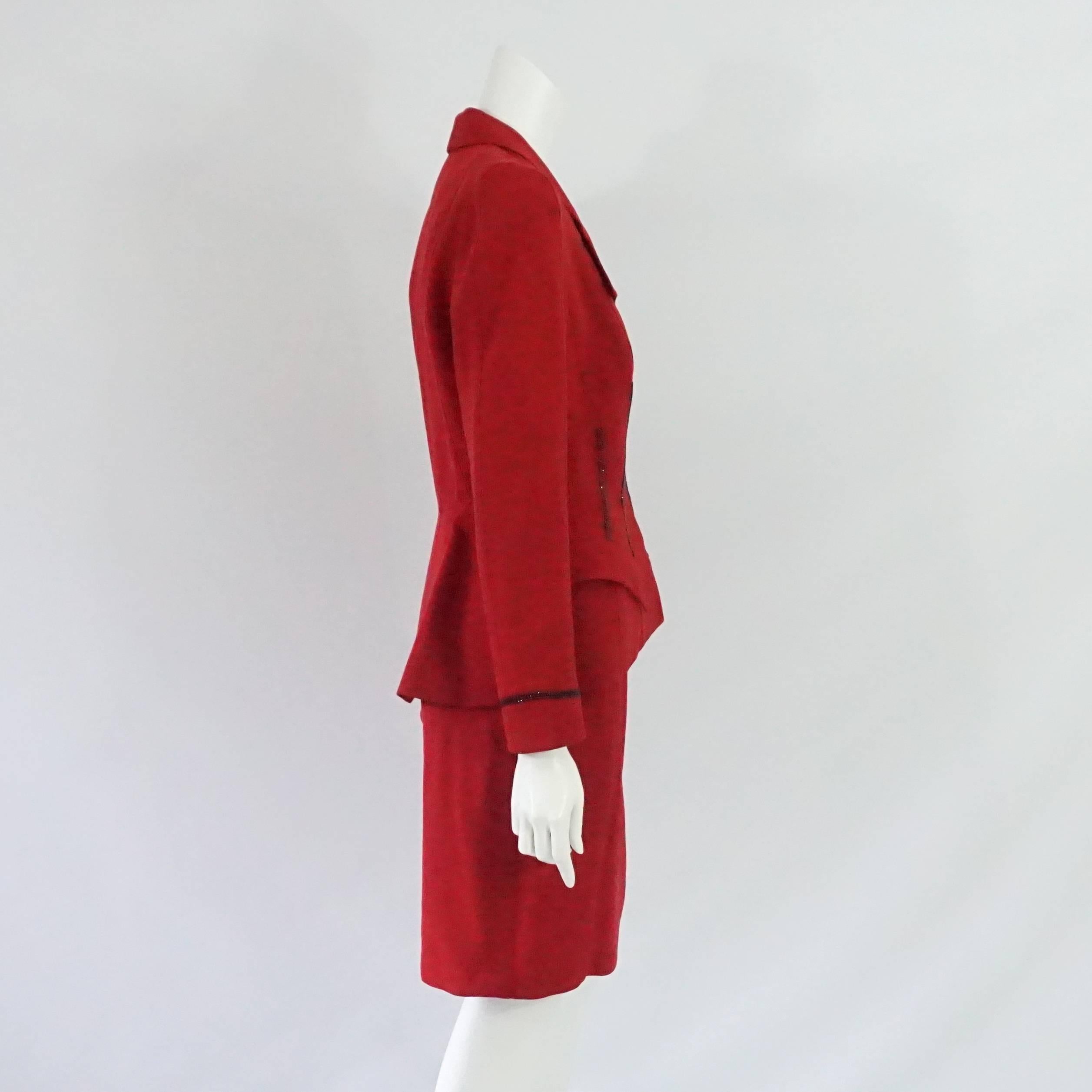 This Thierry Mugler red wool skirt suit has rhinestone detailing on the front and cuffs. There are 2 angular pockets on the front, a collar, and shoulder pads. This skirt suit is in very good condition.

Jacket Measurements
Shoulder to