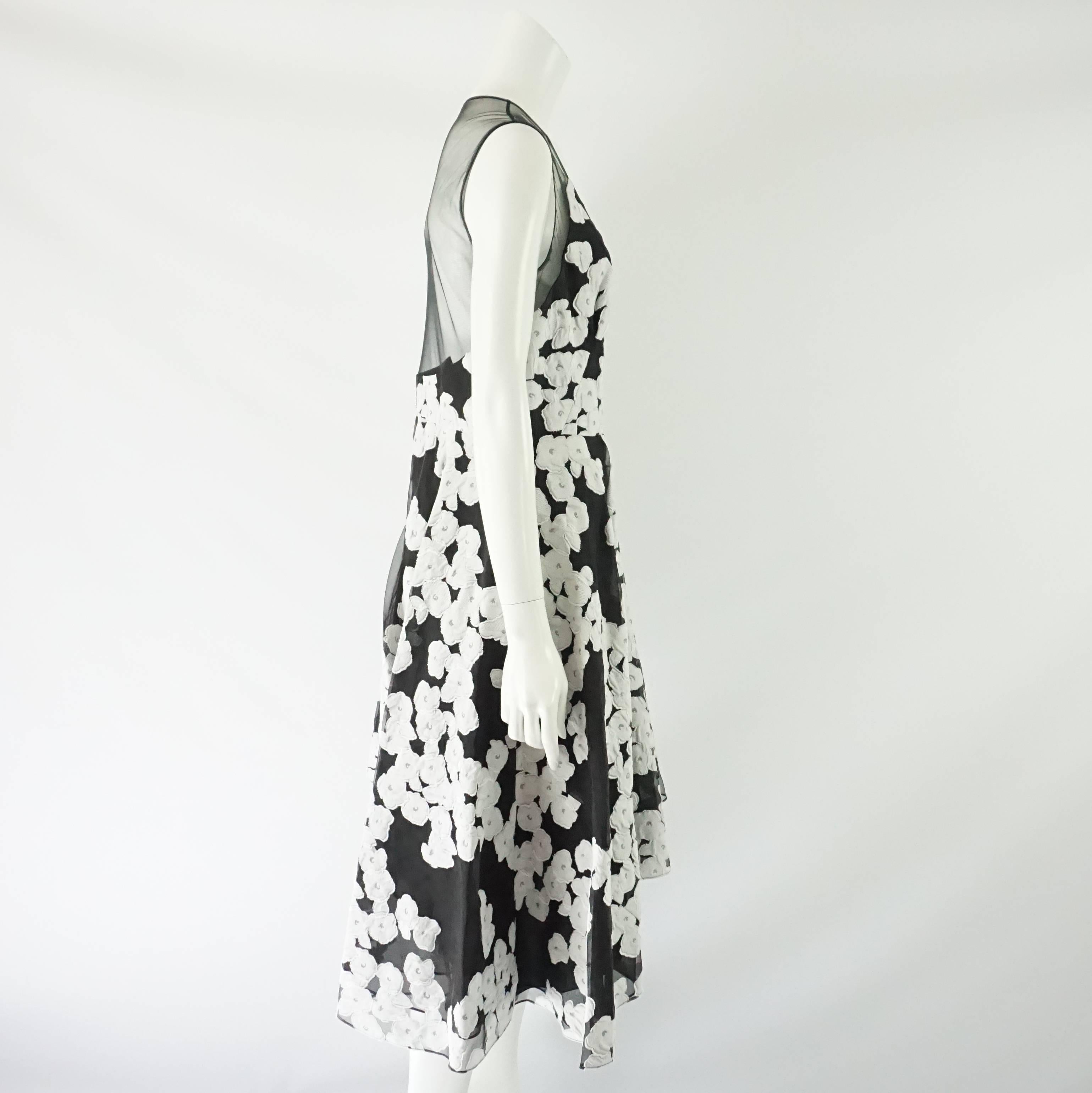 This Lela Rose dress has a black and white floral print with a v-neck. The back and shoulders are mesh. The skirt features an asymmetrical hem. This dress is in excellent condition.

Measurements
Bust: 36