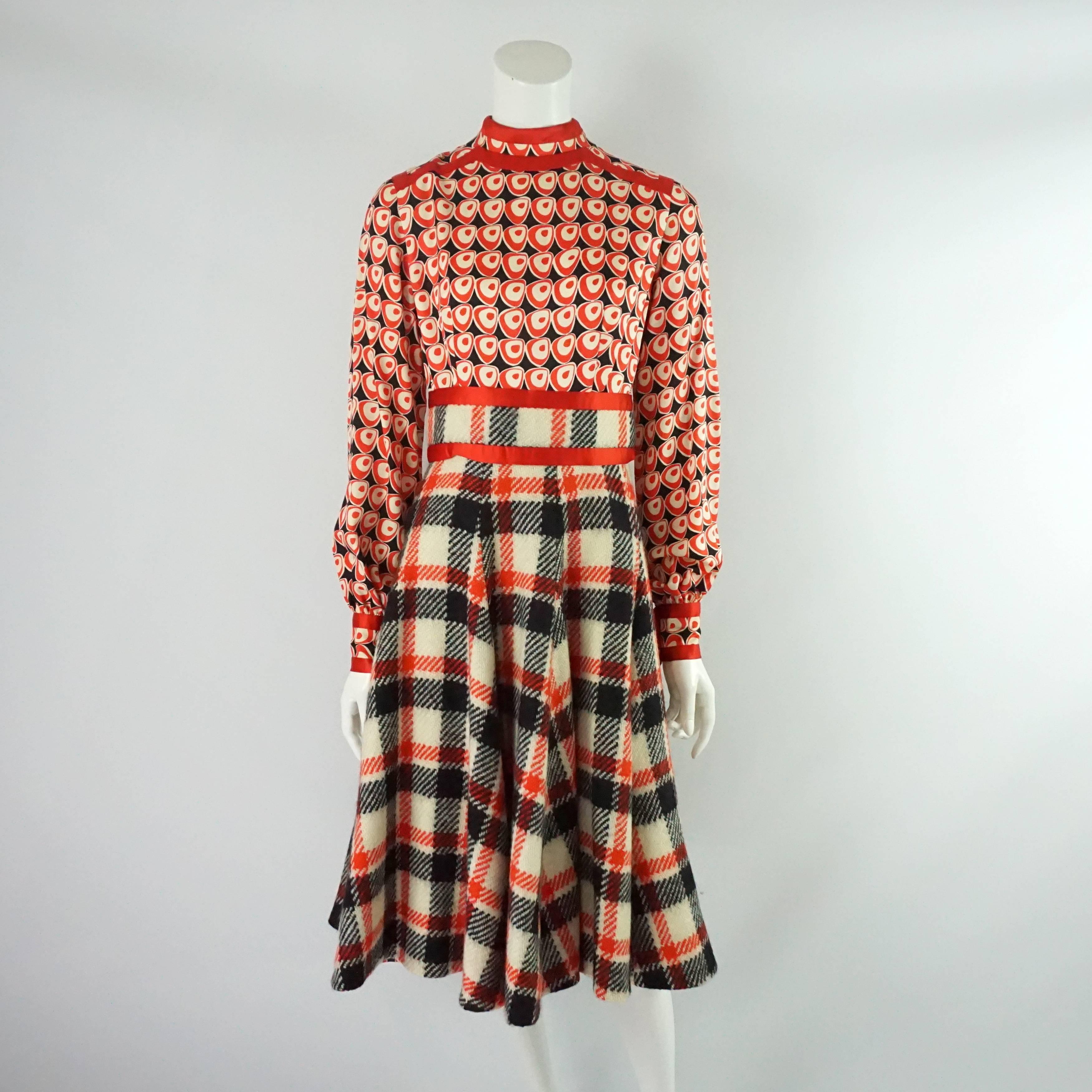 This classic yet funky Ronald Amey set comes with a long sleeve dress and jacket. The dress' bodice is a silk geometric print with a wool plaid skirt and red silk trim; it also has pockets in the front. The jacket is also a plaid wool with the red