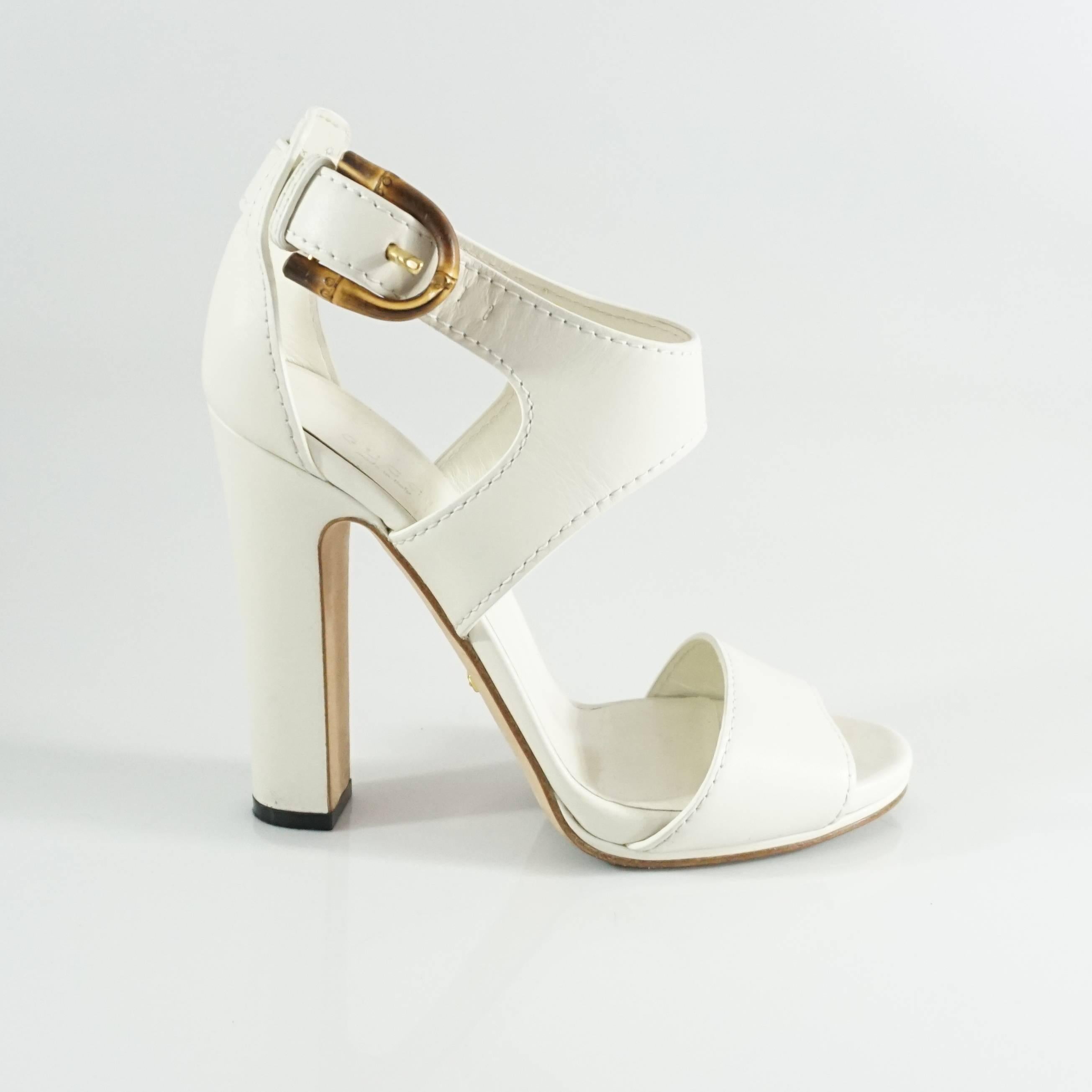 These Gucci white leather heels are strappy and open-toe. They have a cutout top and bamboo buckle closure. The heels are in excellent condition with some wear on the bottom and minor leather wear. Size 38.

Heel Height: 4.75