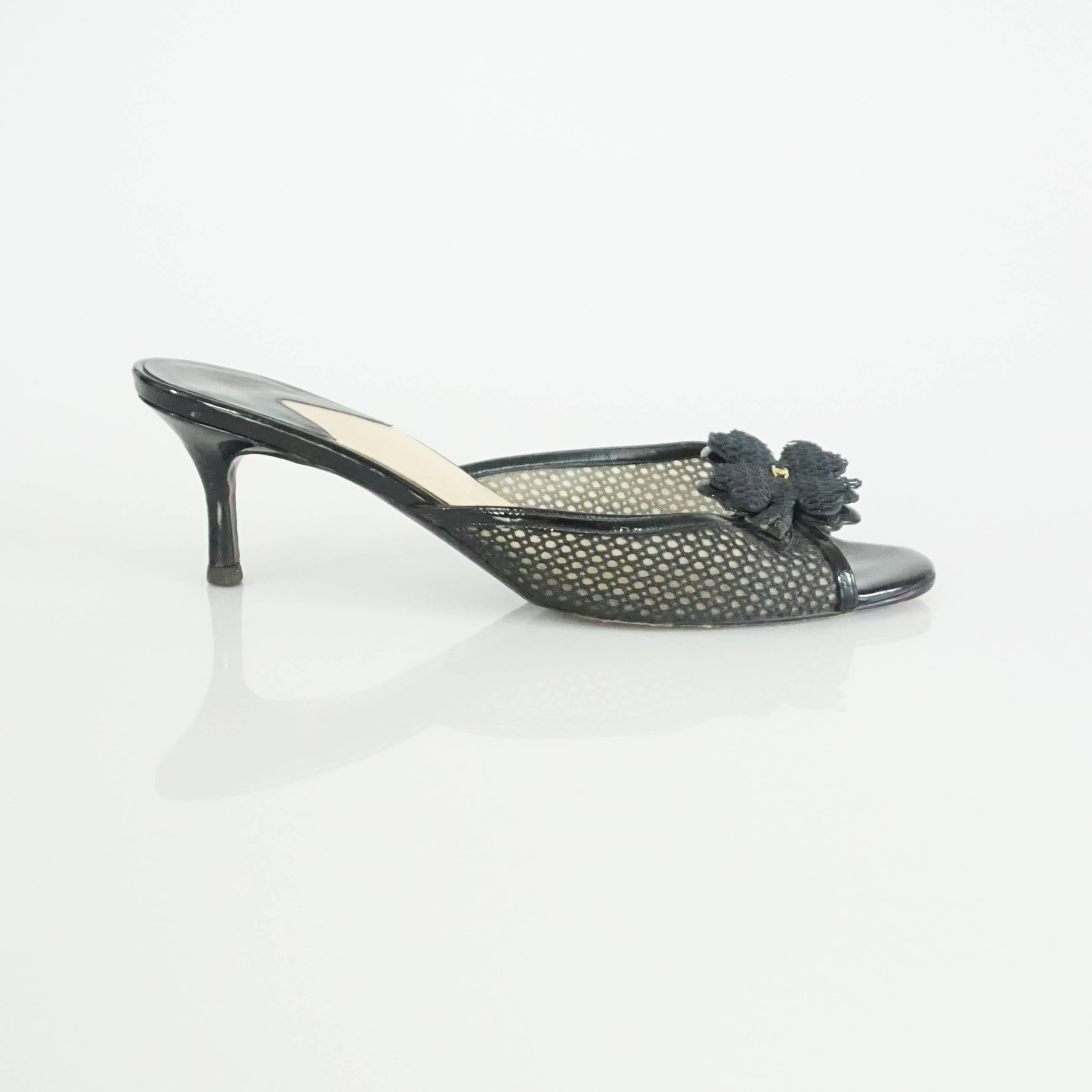 This Chanel black mesh covered slide heels have a clover motif with a small gold CC on them. They are in excellent condition with light wear on the heel as shown in the last image. Size 38. 

Heel Height: approx 2.75