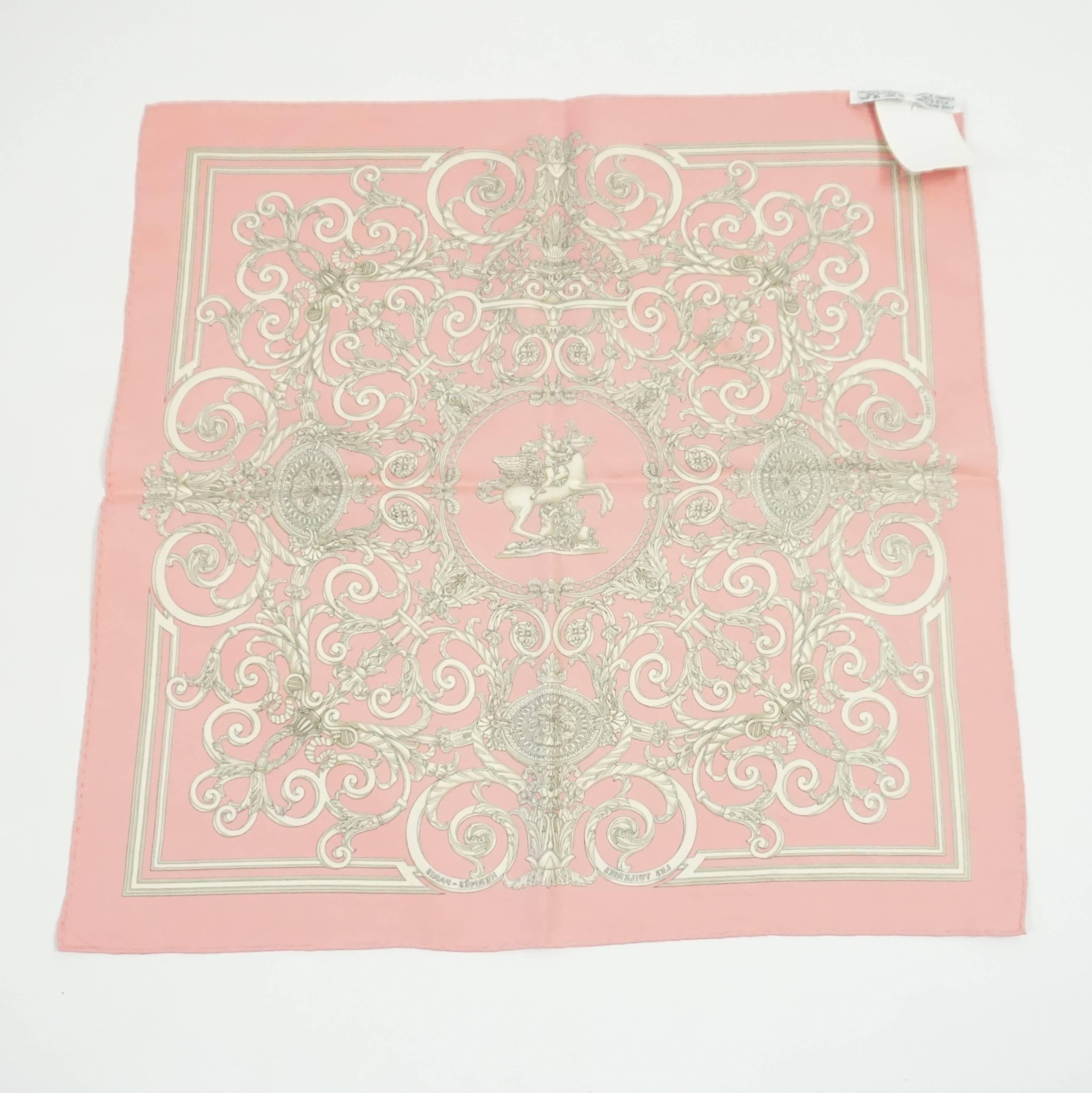 This Hermes pocket square is pink with a light gold Renaissance print. Its theme is 