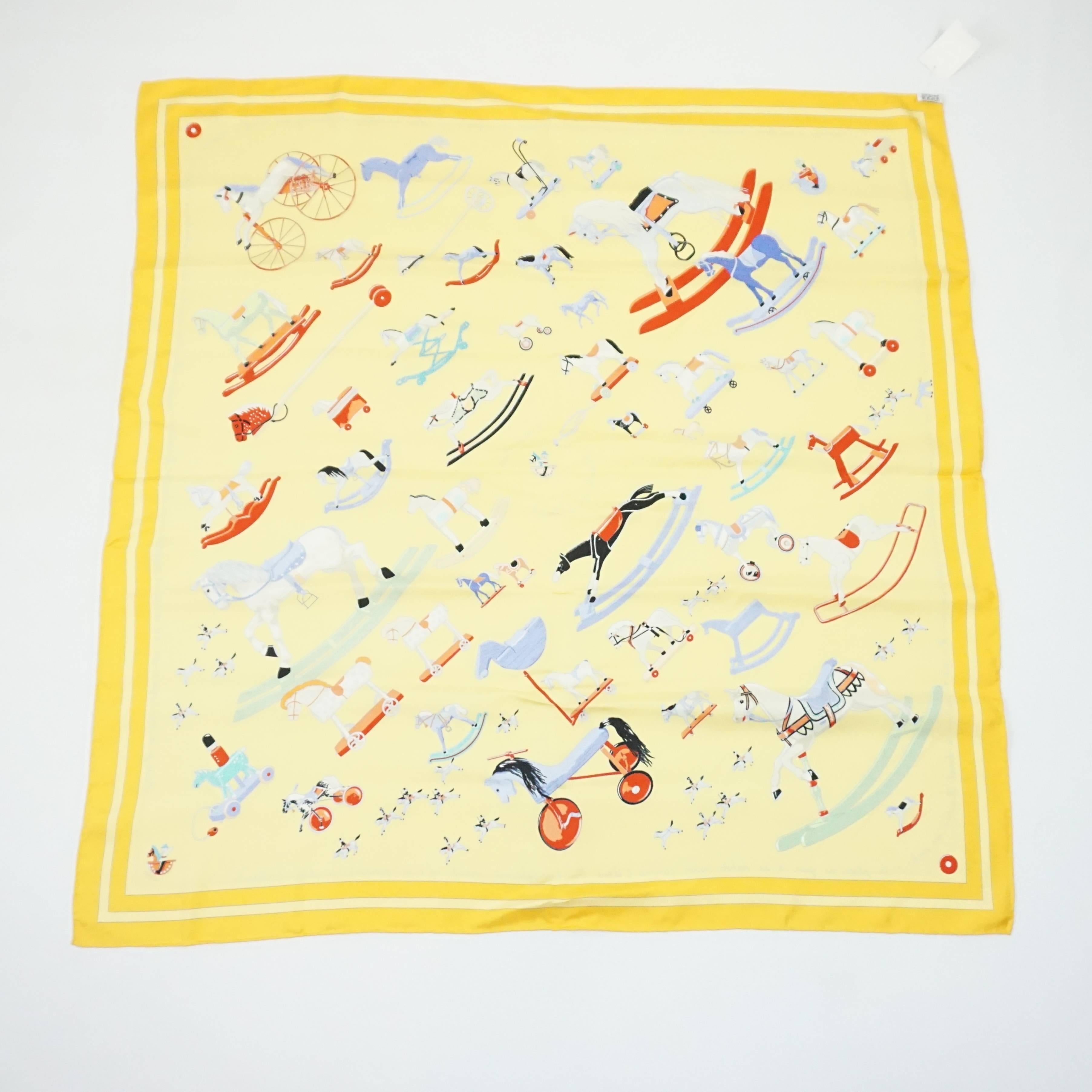 This Hermes scarf is a bright yellow with a multi color rocking horse print on it. The theme is "Raconte-moi le Cheval" and it is in excellent condition with light wear.

Measurements
Length: 35"
Width: 35" 

