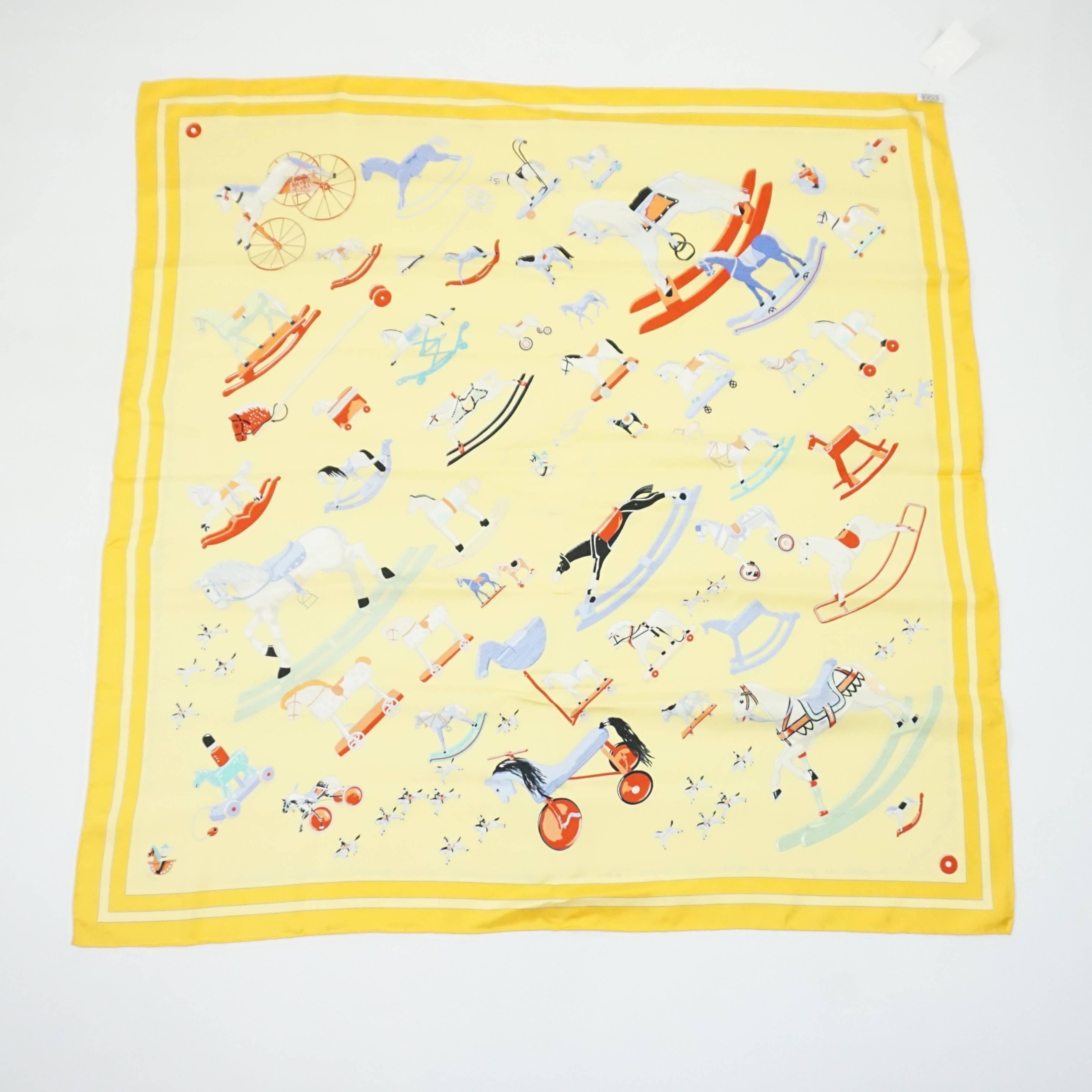This Hermes scarf is a bright yellow with a multi color rocking horse print on it. The theme is "Raconte-moi le Cheval" and it is in excellent condition with light wear.

Measurements
Length: 35"
Width: 35" 
