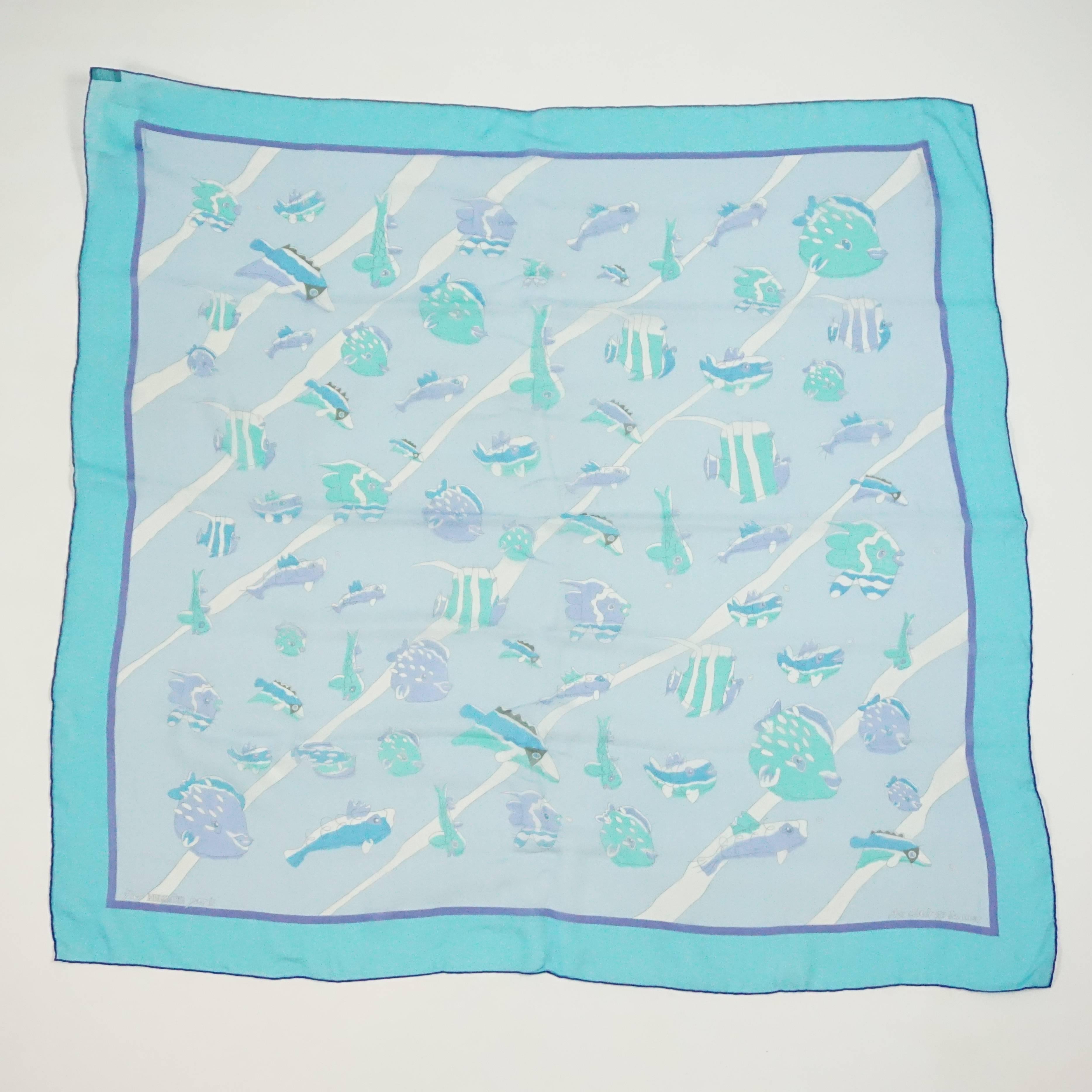 This Hermes scarf is silk chiffon and has a fish print on it. The title is 