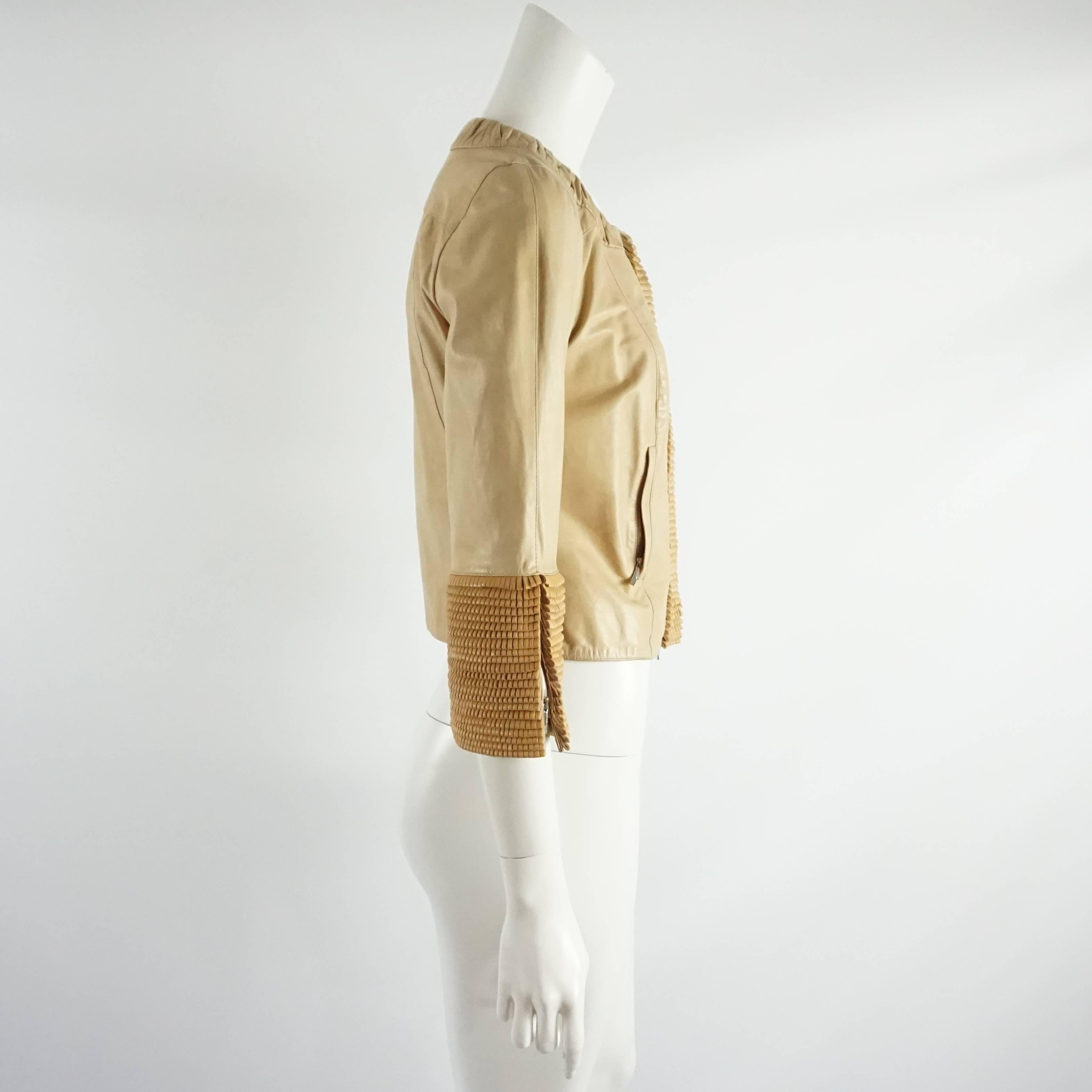 This Fendi tan leather jacket is a unique piece. It features a round neck with ruching, layered fringe loops, and zip closures in the center and cuffs and Bracelet Sleeve. Size 40.

It is in very good condition with light wear as seen in the