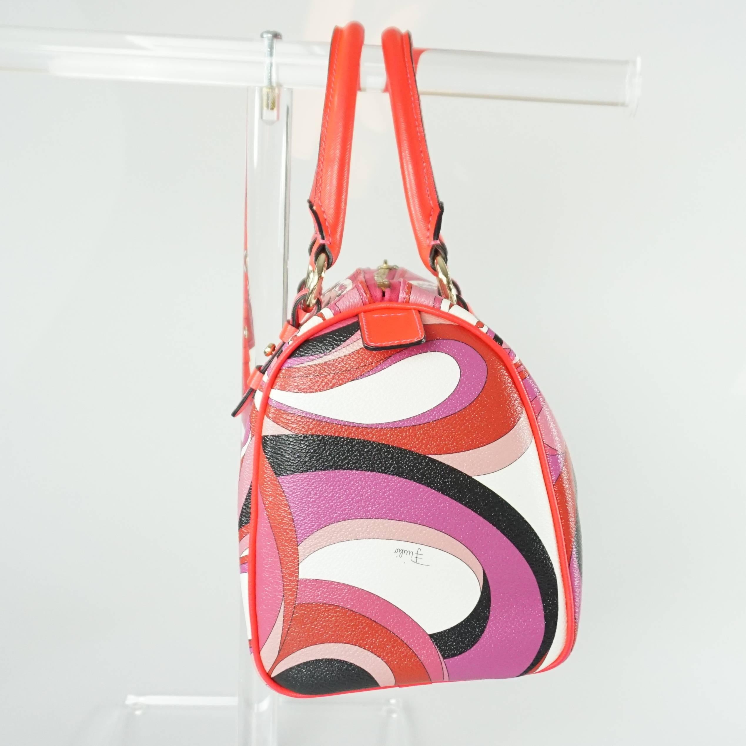 This Emilio Pucci pink printed doctor bag is a perfect summer bag. It features a geometric print in different hues of pink and neon pink handles and trim. 

It is in excellent condition with very minor wear. 

Measurements
Height: 8.5