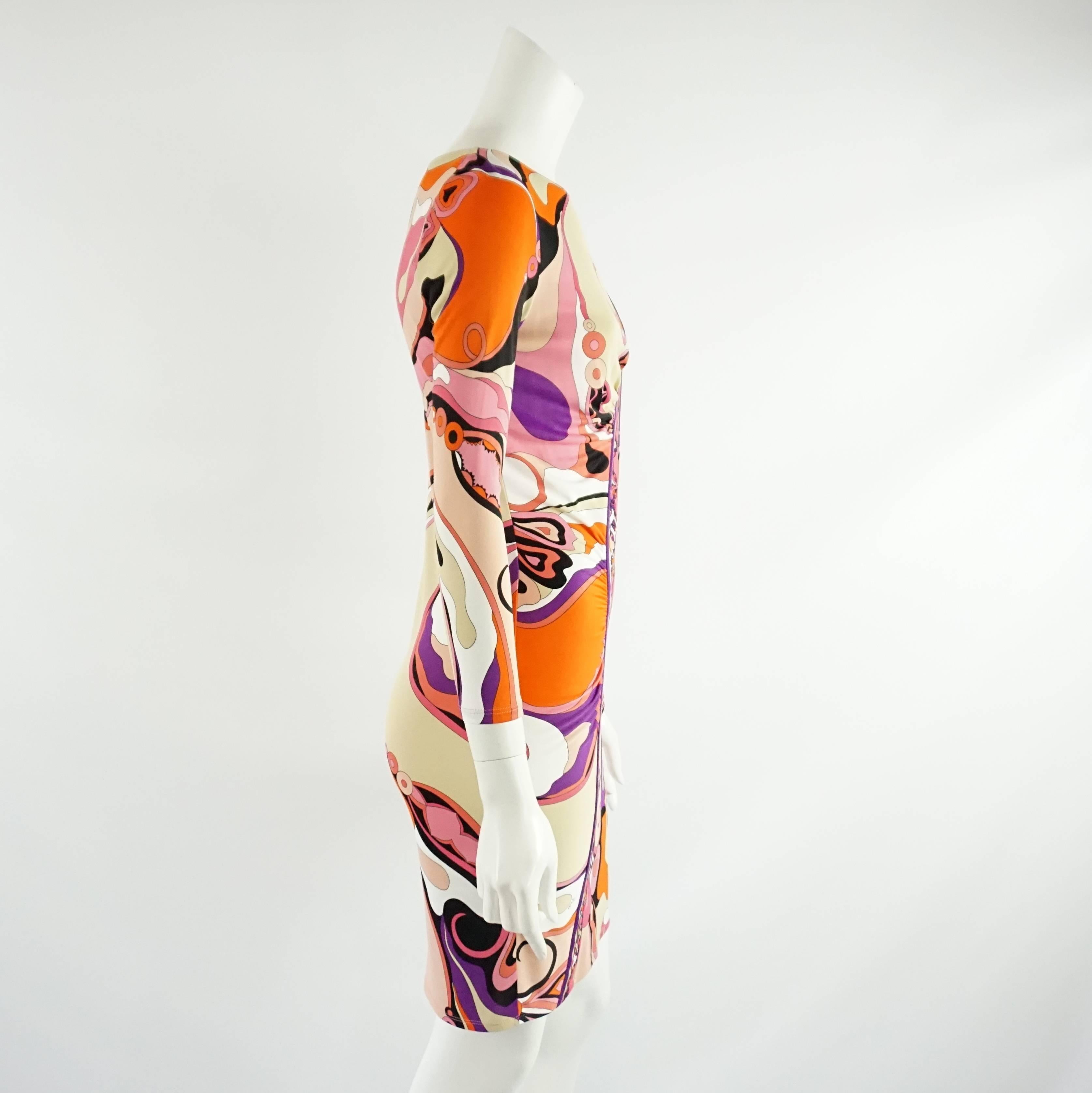 This fun Emilio Pucci dress has long sleeves and features an orange, pink, and purple print. This dress is in very good condition with some minor wear and is a size 6.

Measurements
Shoulder to Shoulder: 14"
Sleeve Length: 22"
Bust: