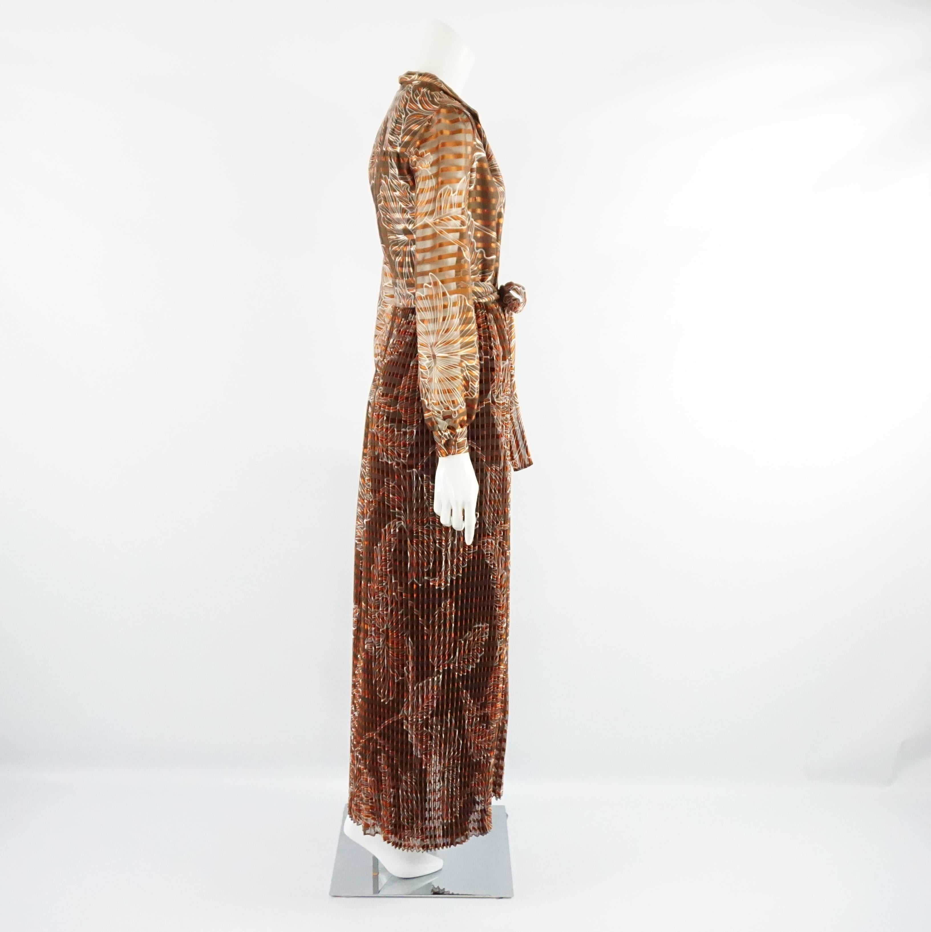This Oscar de la Renta vintage rust colored silk organza gown features a print. There is a waist tie. This gown is in very good condition with minor overall wear.

Measurements
Shoulder to Shoulder: 15.5"
Sleeve Length: 24.5"
Bust: