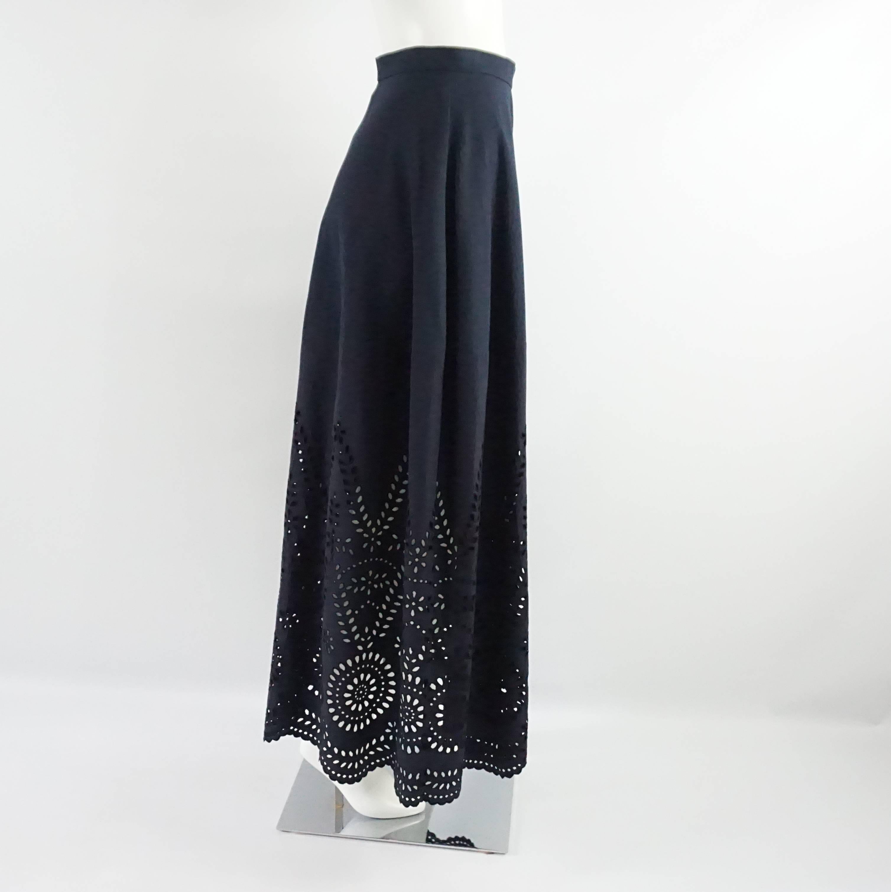 This Stella McCartney long navy cotton skirt features an eyelet design on the bottom. This skirt is in excellent condition.

Measurements
Waist: 27"
Length: 40.25"