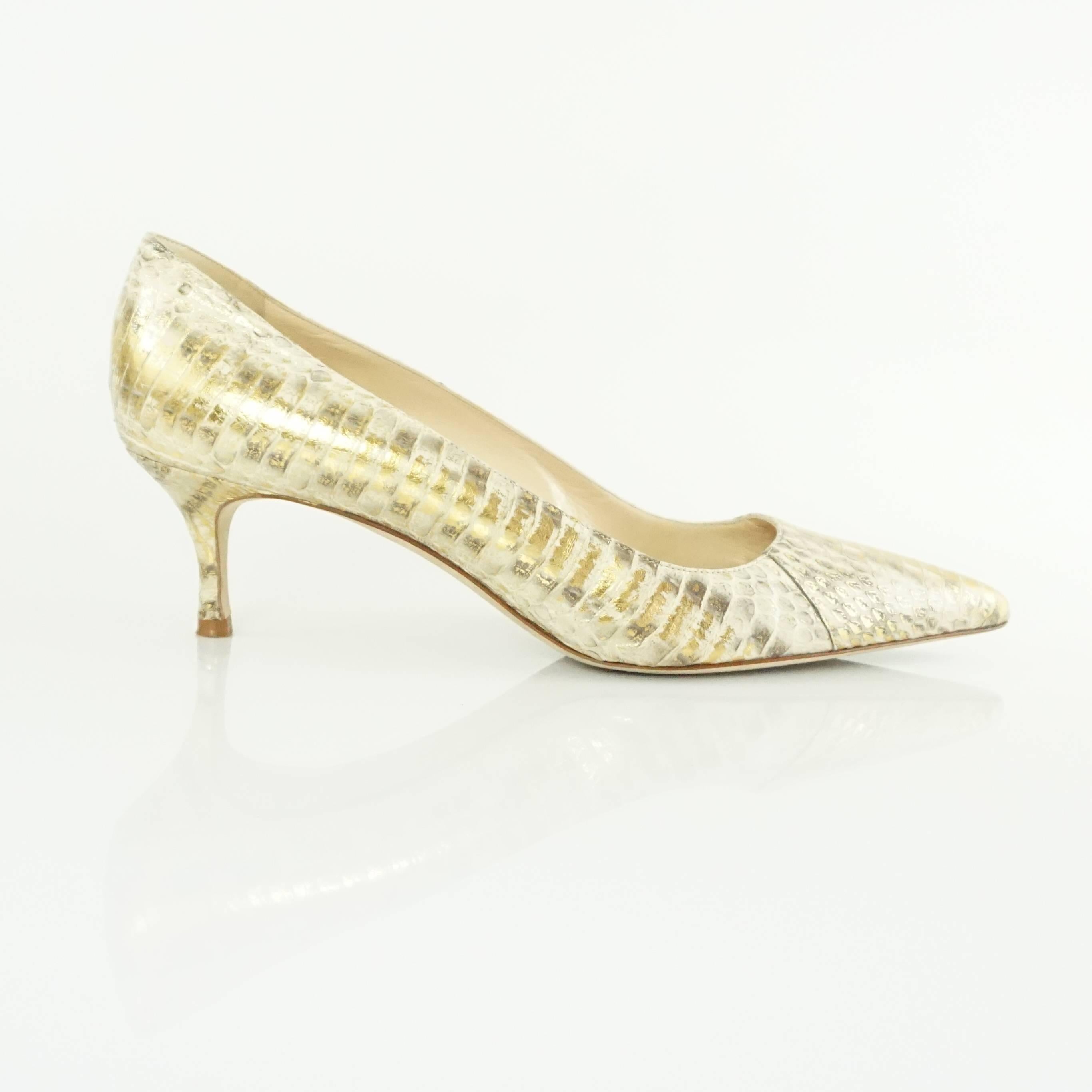 These Manolo Blahnik pointed toe pumps are made of gold python and have a kitten heel. They are in very good condition with some bottom wear and minor wear.

Measurement
Heel Height: 2